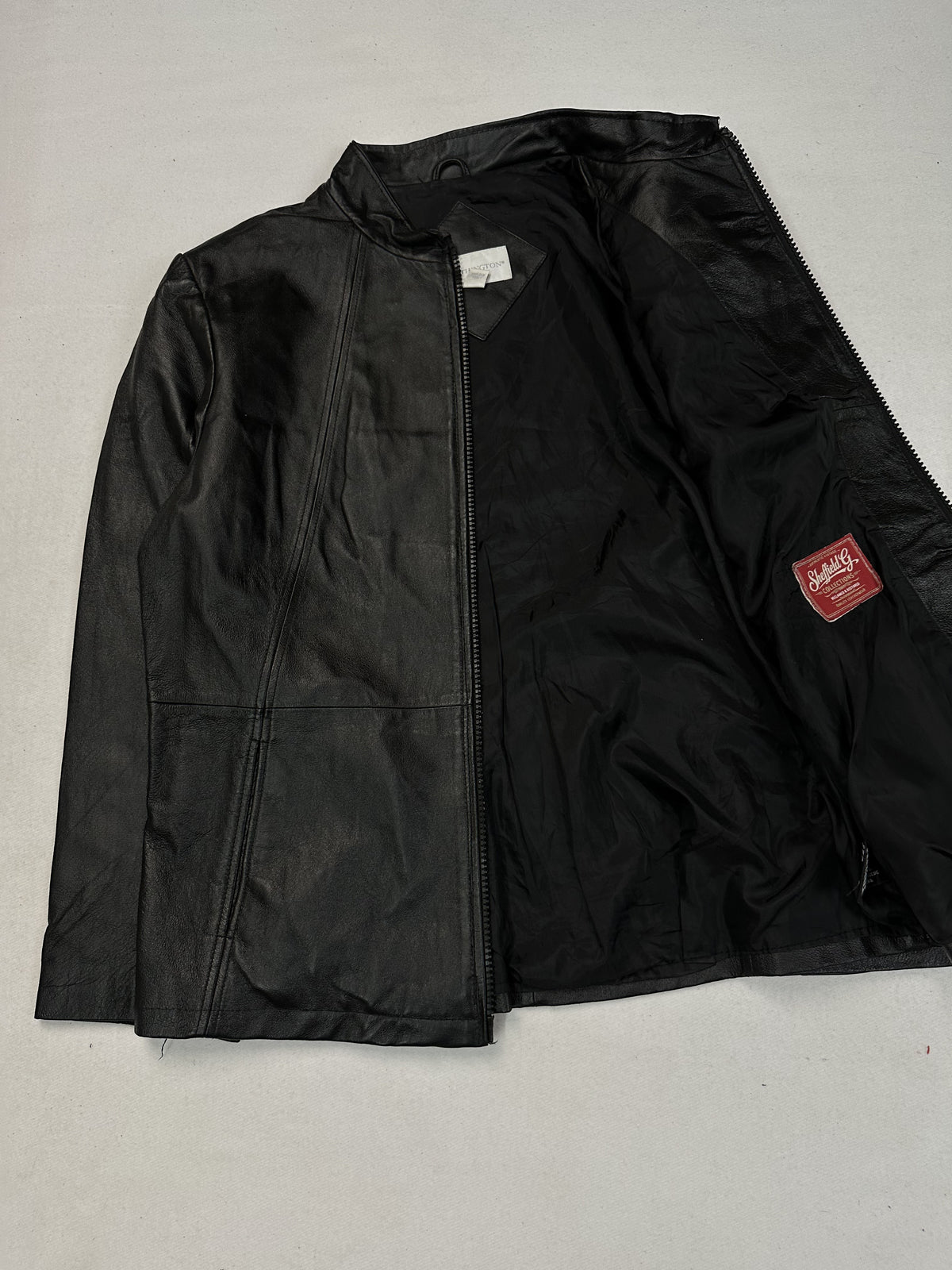 Black leather cafe racer jacket, size L - cuff and hem detail.