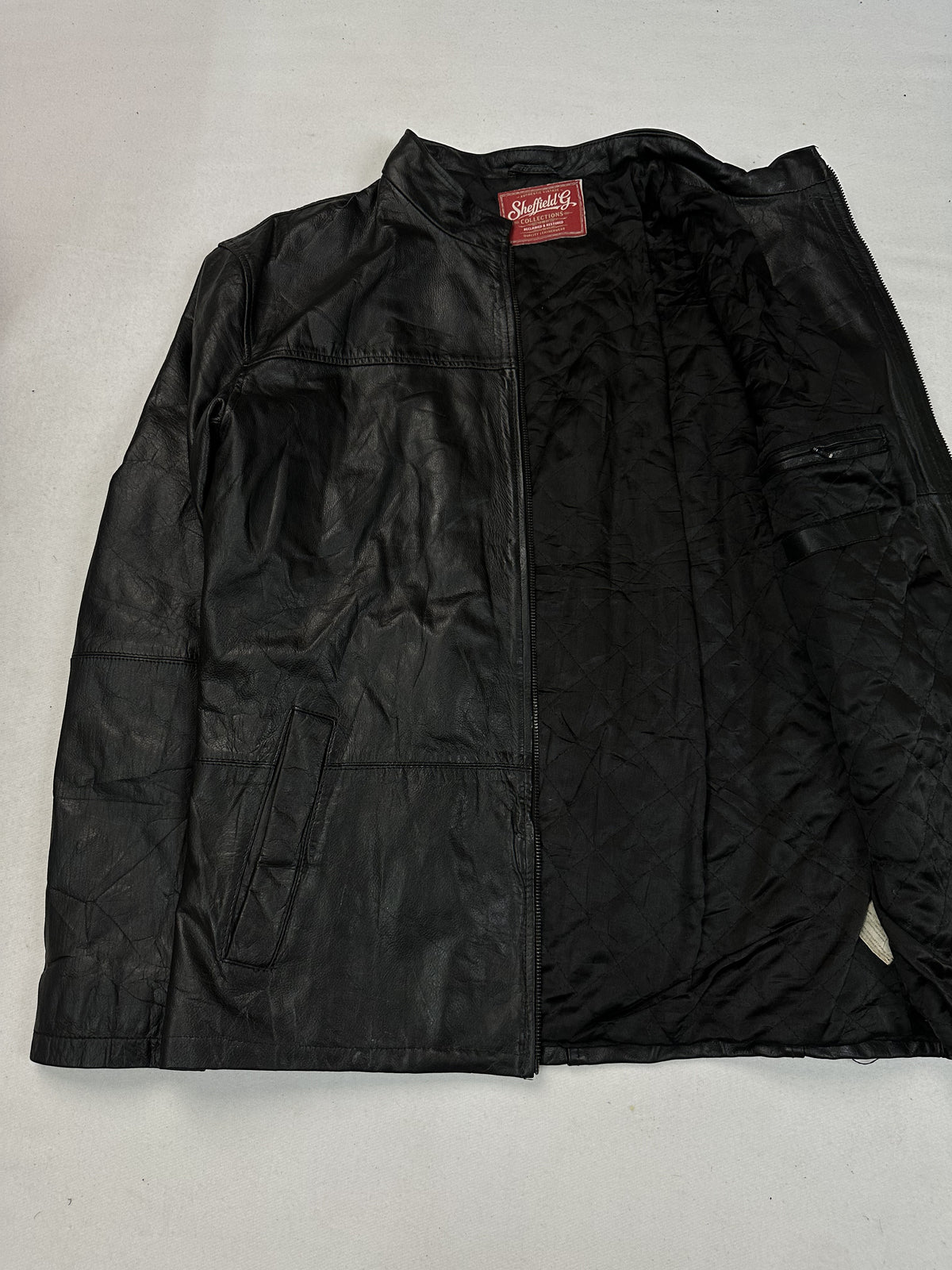 Black leather vintage jacket, size L - cuff and hem detail.