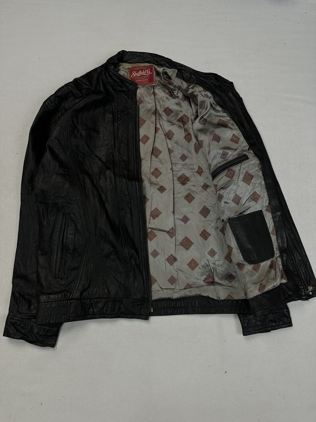 Black leather vintage jacket, size L - cuff and hem detail.