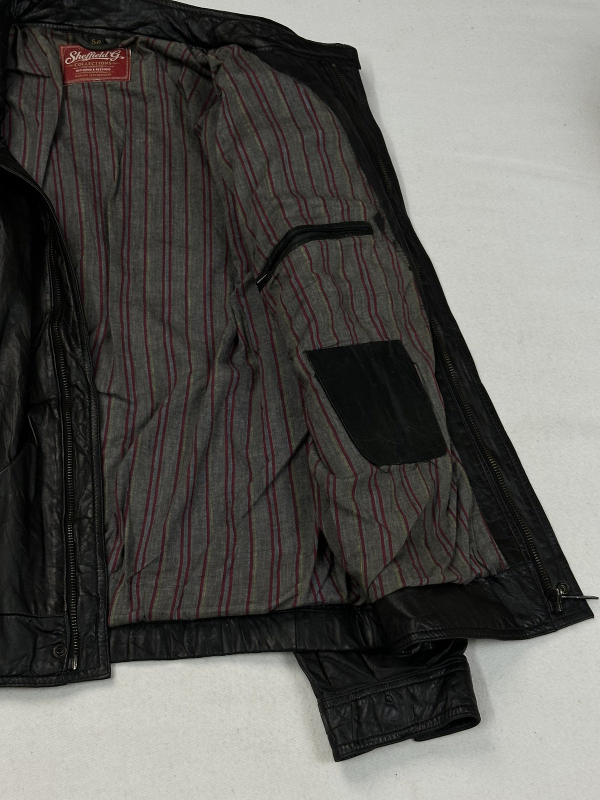 Black leather cafe racer jacket, size L - cuff and hem detail.