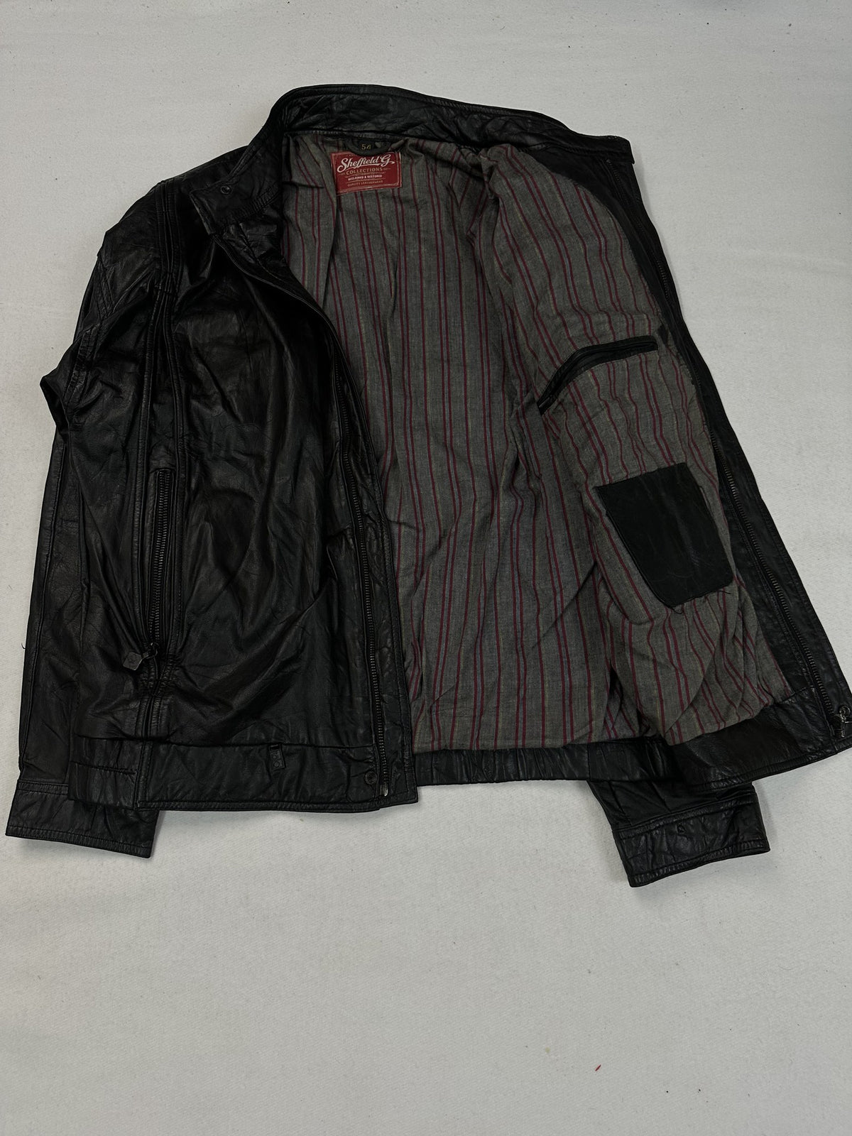 Black leather cafe racer jacket, size L - front closure detail.