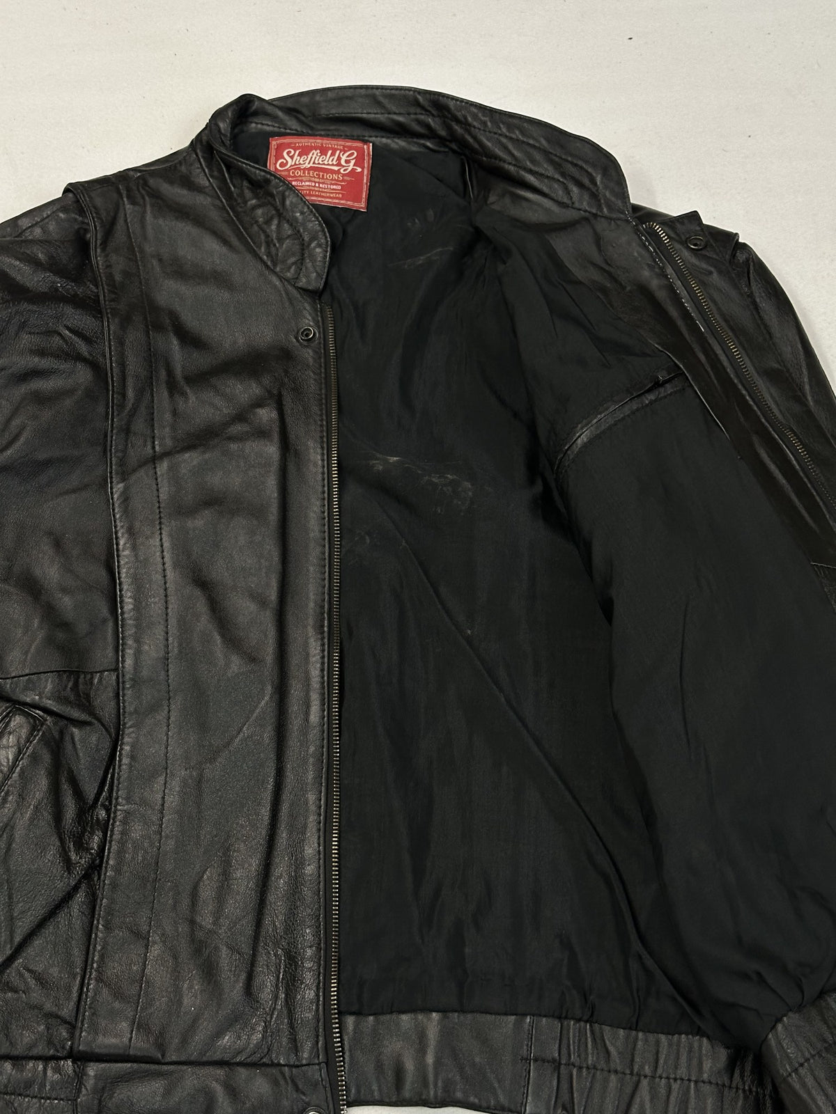 Black leather vintage jacket, size M - cuff and hem detail.