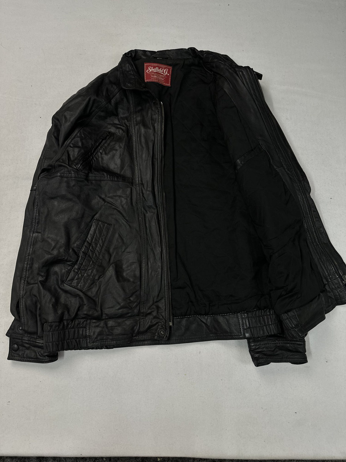 Black leather vintage jacket, size L - cuff and hem detail.