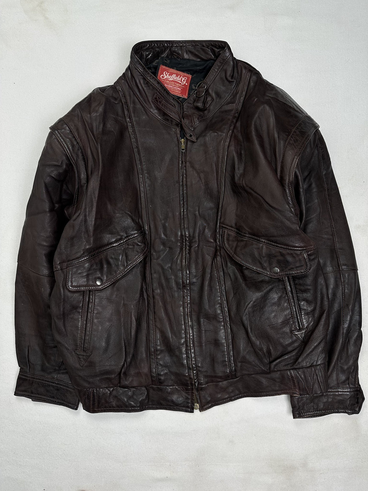 Front of the size L burgundy leather flight jacket, laid flat and unedited
