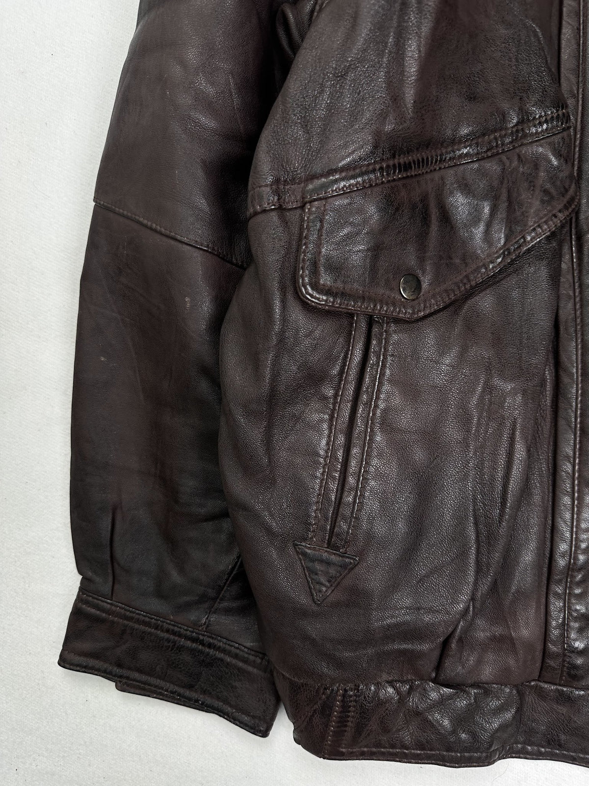 Close detail of the pockets and cuff on the size L burgundy leather flight jacket