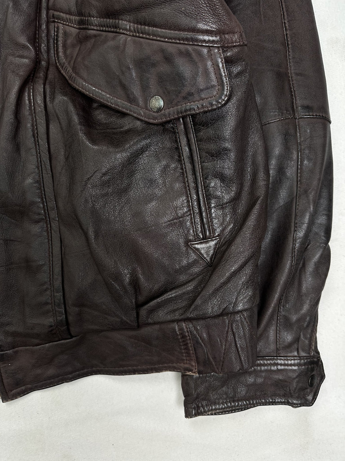 Side pocket and hem of the size L burgundy leather flight jacket, up close