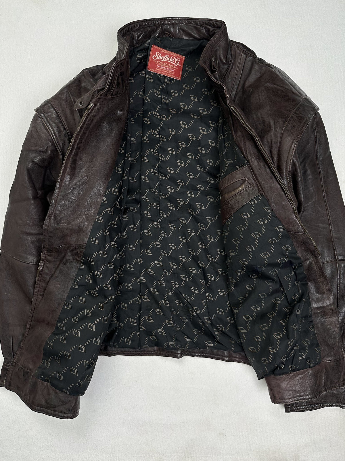 The size L burgundy leather flight jacket opened to show the lining