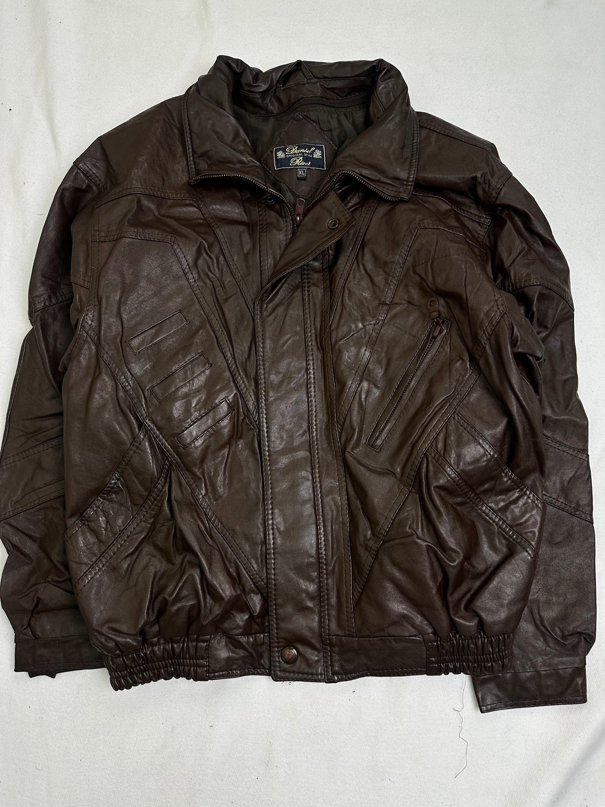Back of the size L brown harrington jacket laid flat