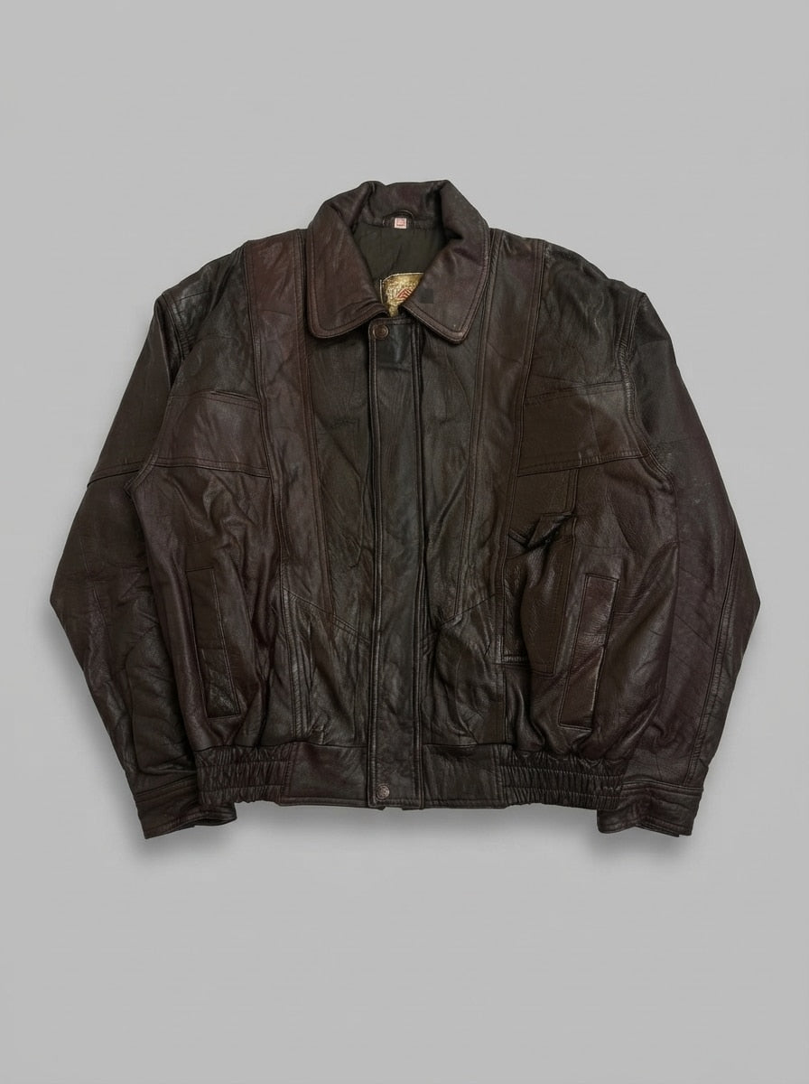 Brown leather harrington jacket, size L, shown flat from the front. Snap-tab pointed collar and chest welt pocket.