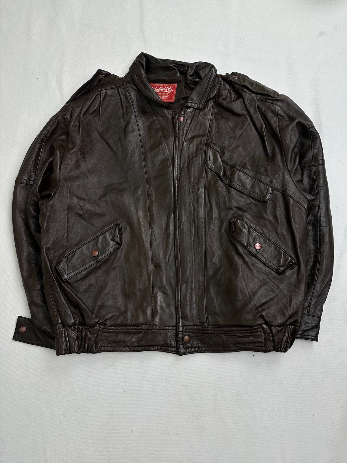 Back of the size L brown vintage jacket laid flat