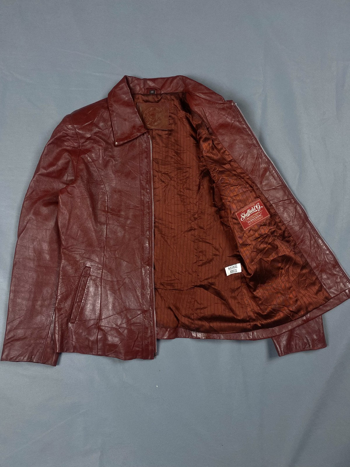 Lining of the burgundy leather biker jacket shown open