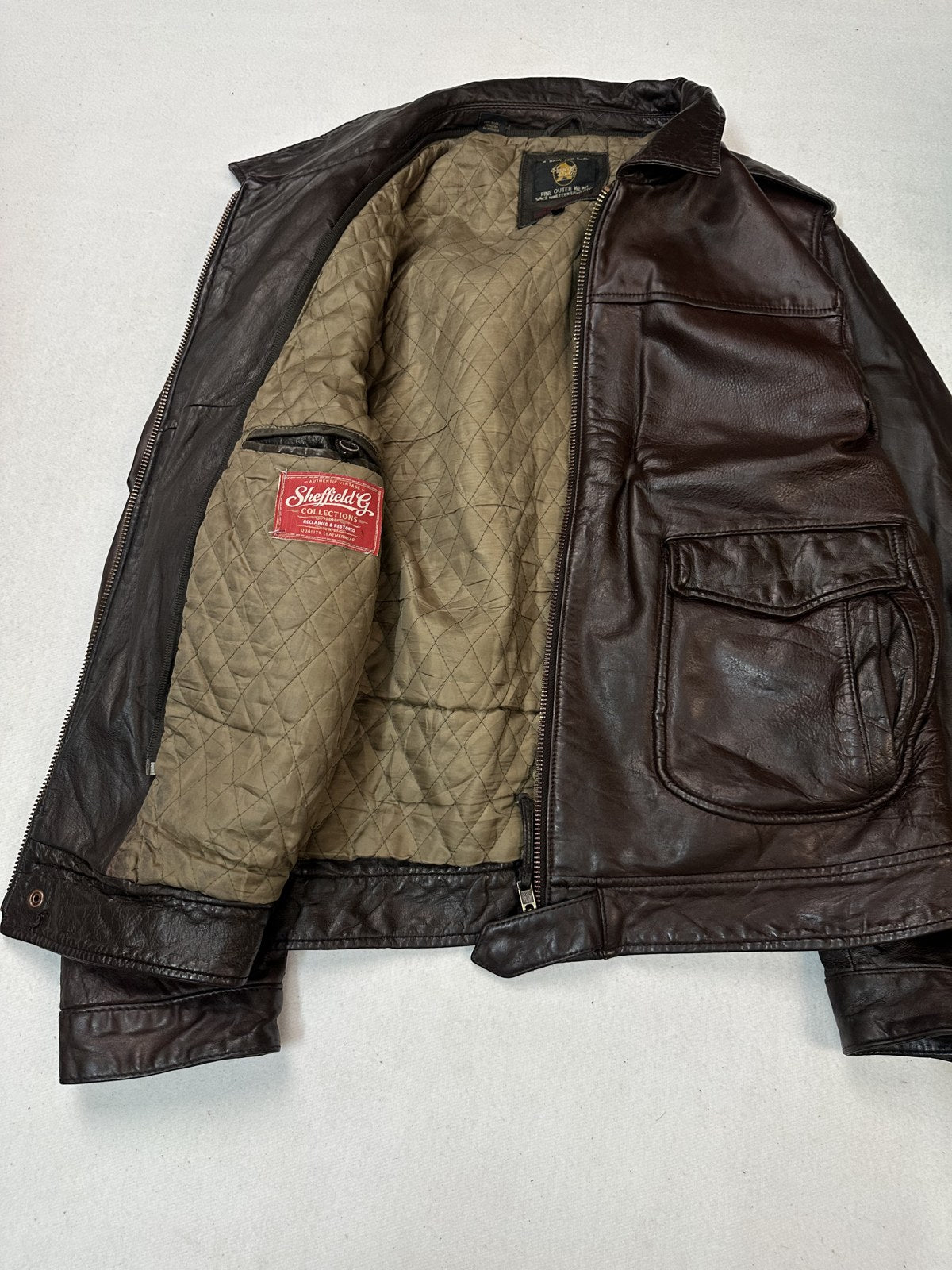 Quilted olive lining inside the burgundy leather biker jacket