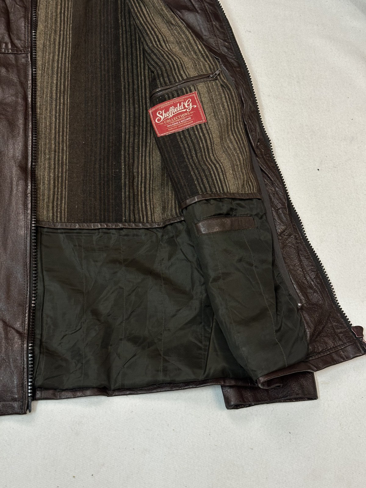 Interior lining and inside seams of the burgundy cafe racer biker jacket