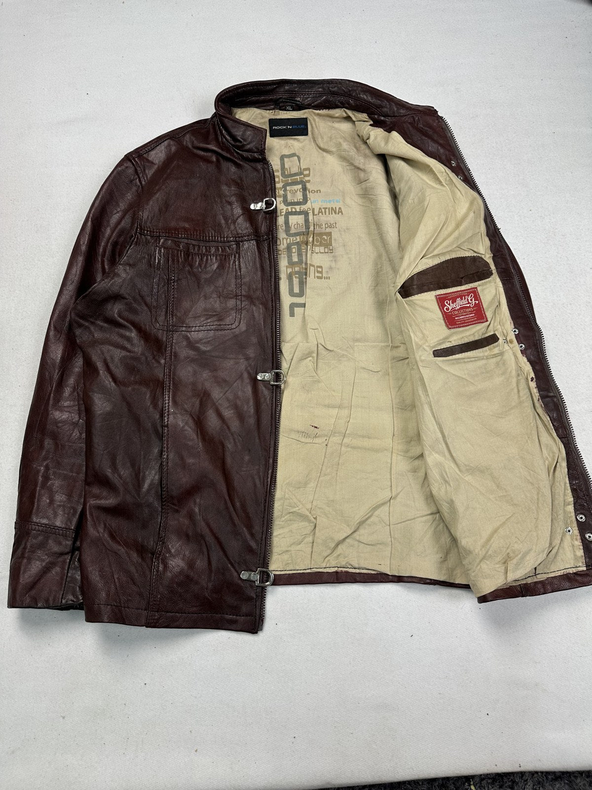 Cream lining inside the burgundy biker jacket, held open to show the interior