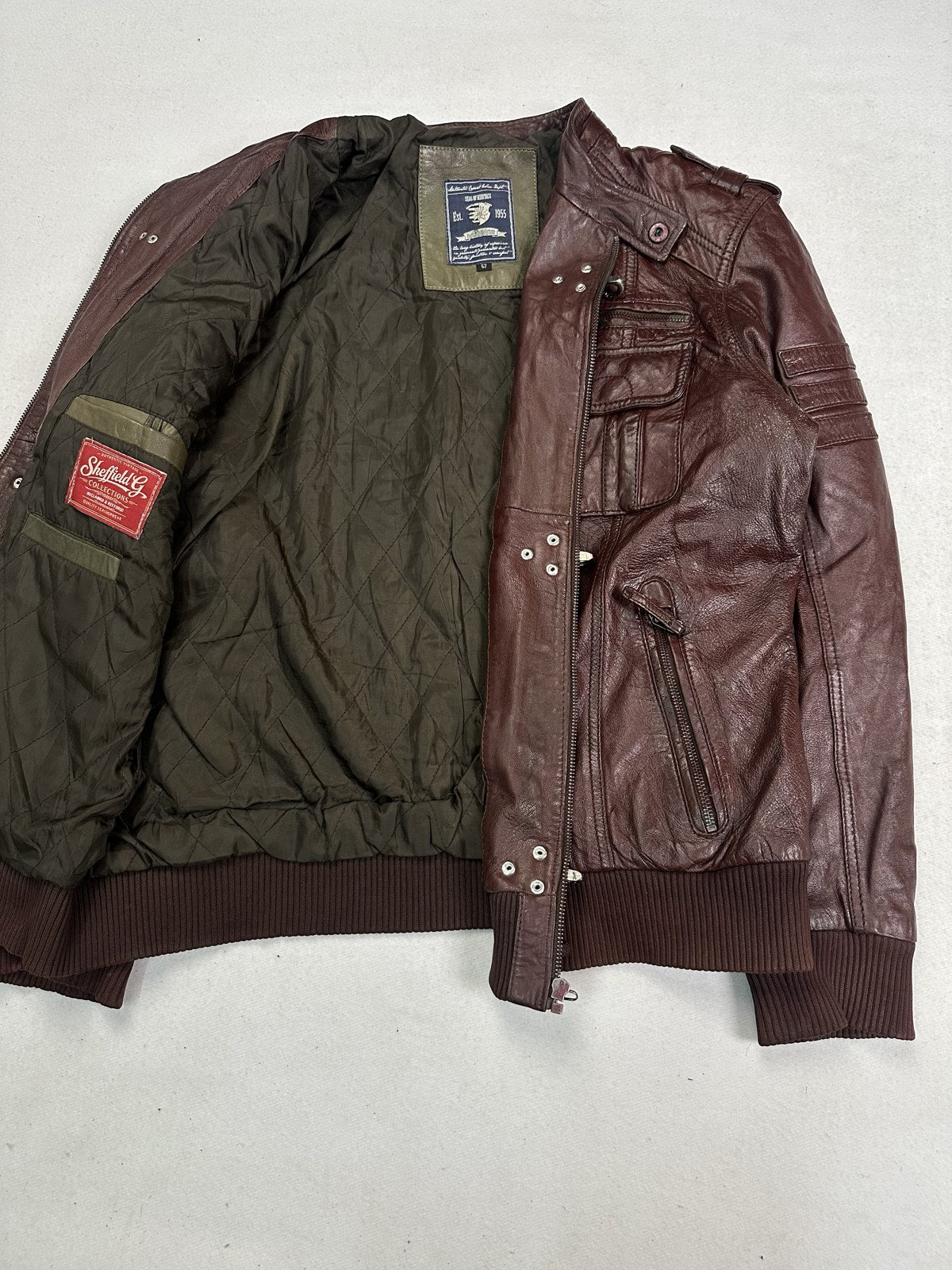 Olive lining inside the burgundy leather biker jacket