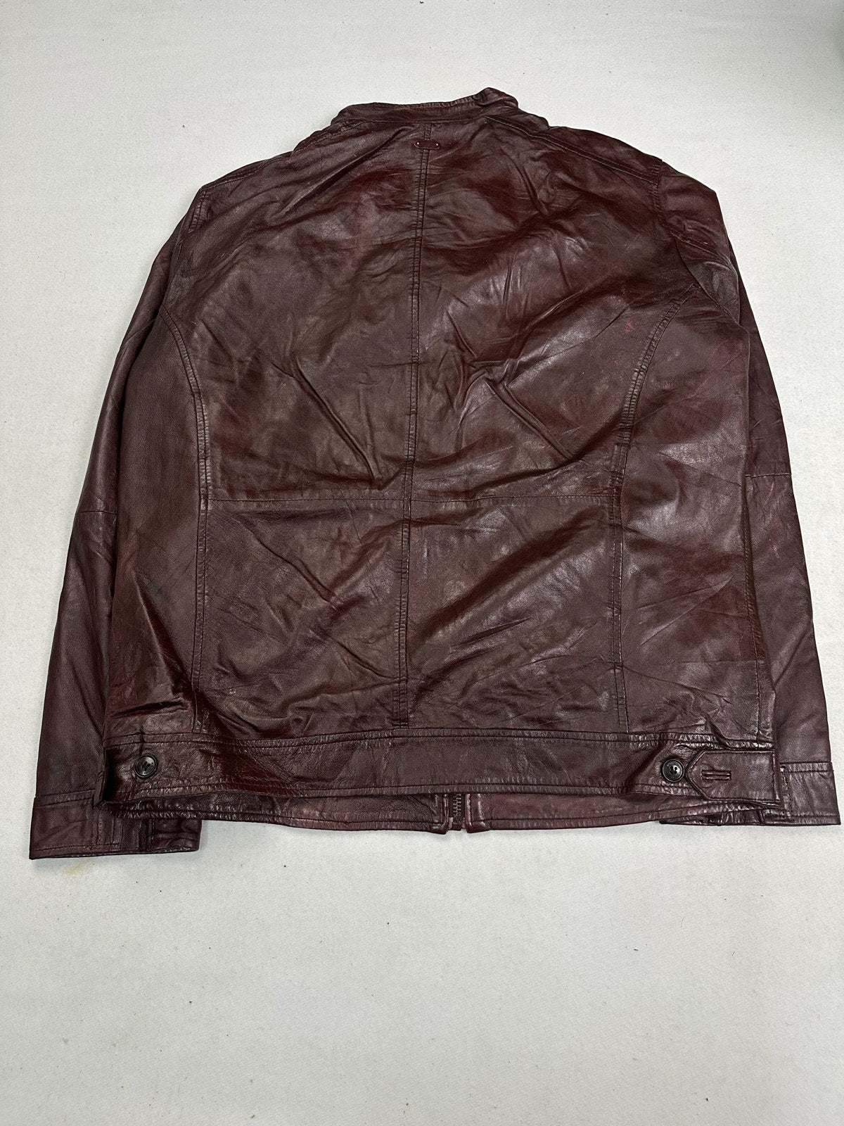 Back view of the XL burgundy biker jacket showing the plain shoulder yoke and slim body