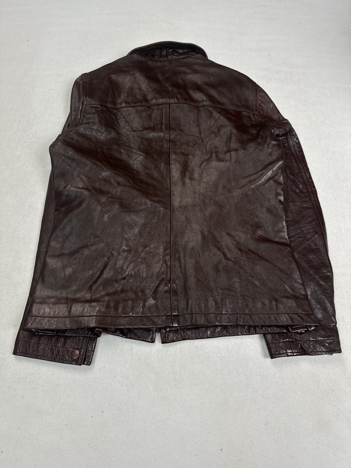 Back of the size S burgundy biker jacket showing the short compact body