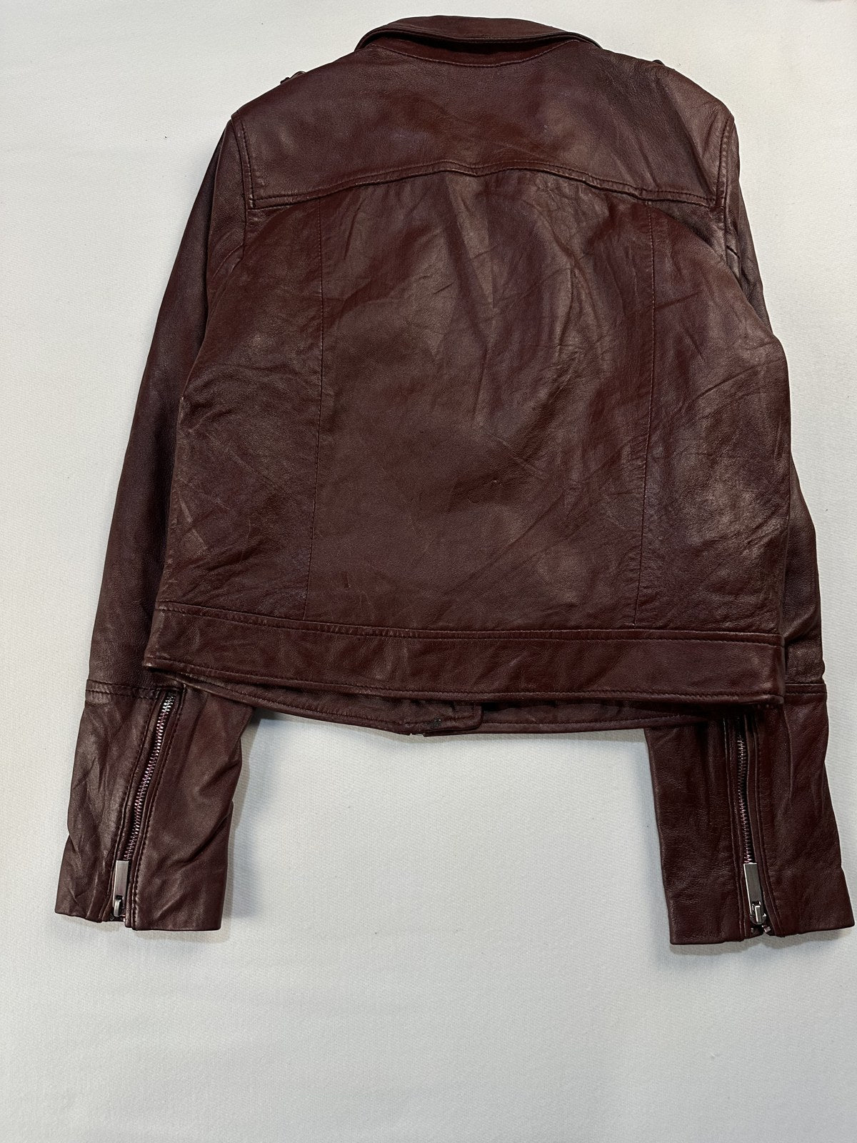 Back of the size S burgundy biker jacket shown flat