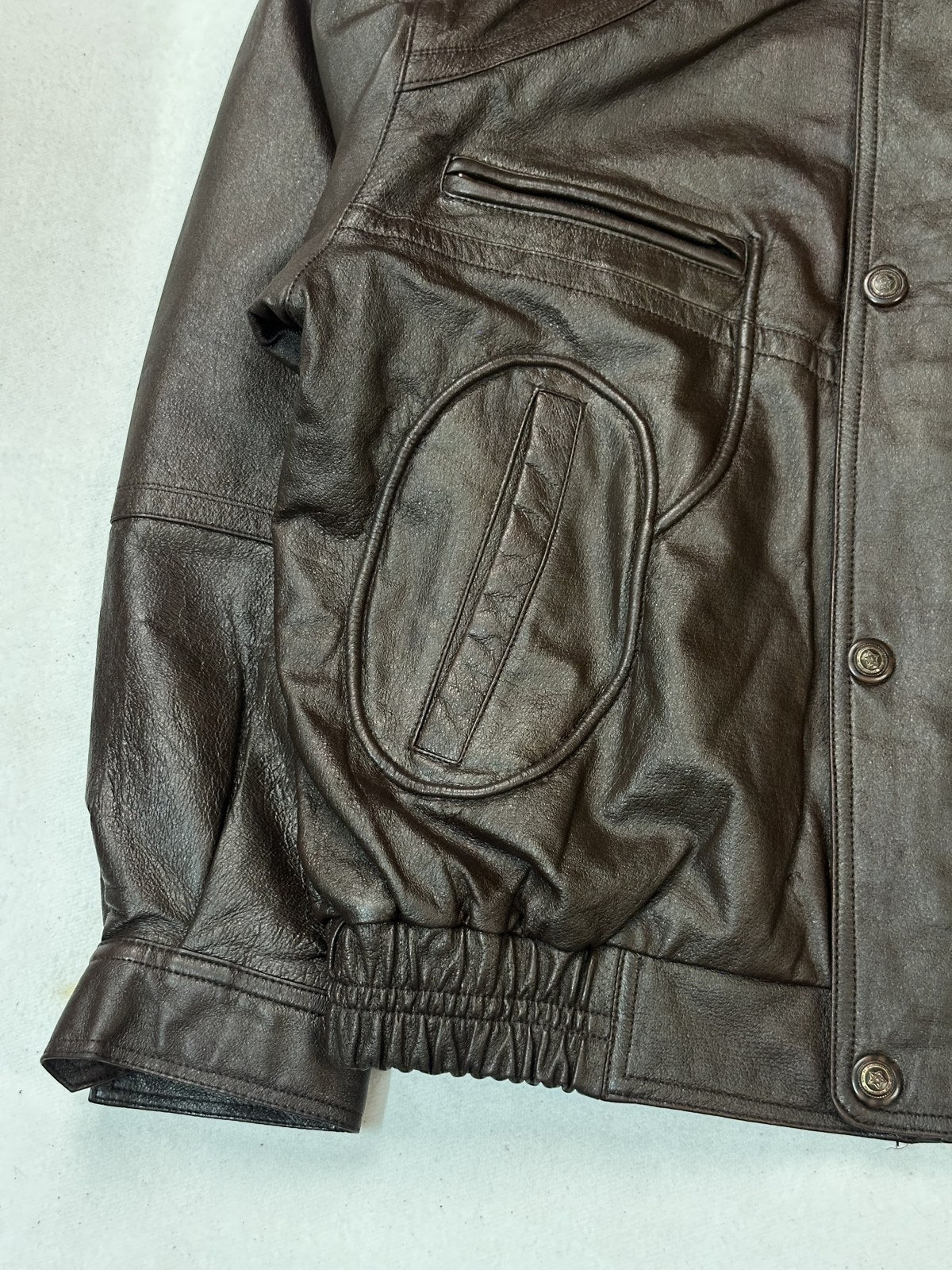 Patterned red lining inside the burgundy leather bomber jacket