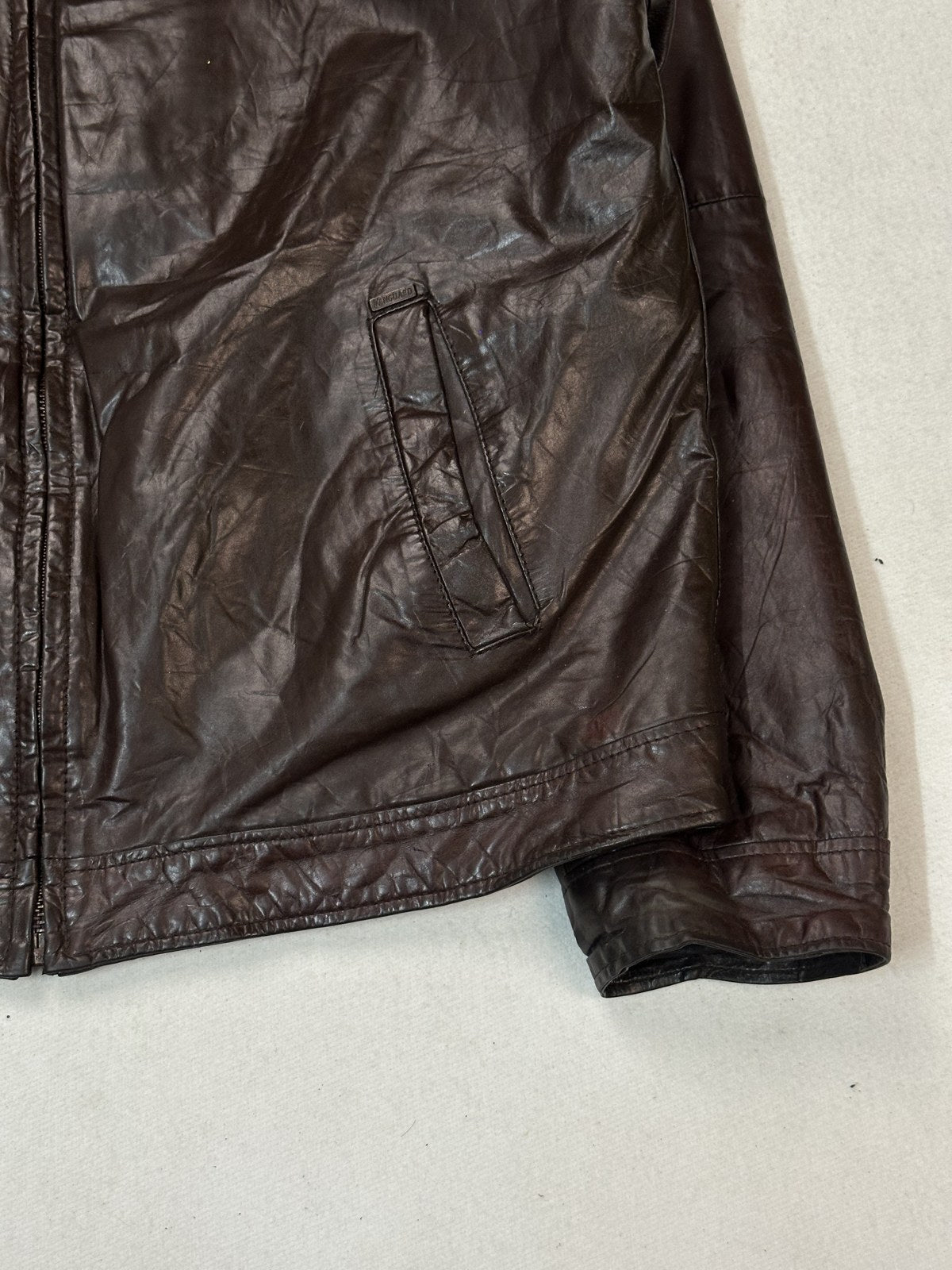 Inside of the burgundy XL bomber jacket with the front held open to show the lining