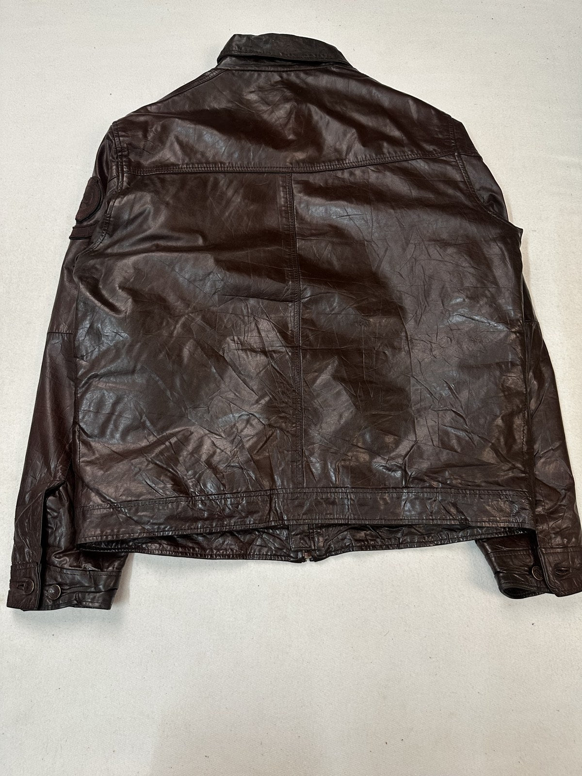 Back of the XL burgundy bomber jacket showing the full leather panel and the knitted rib hem