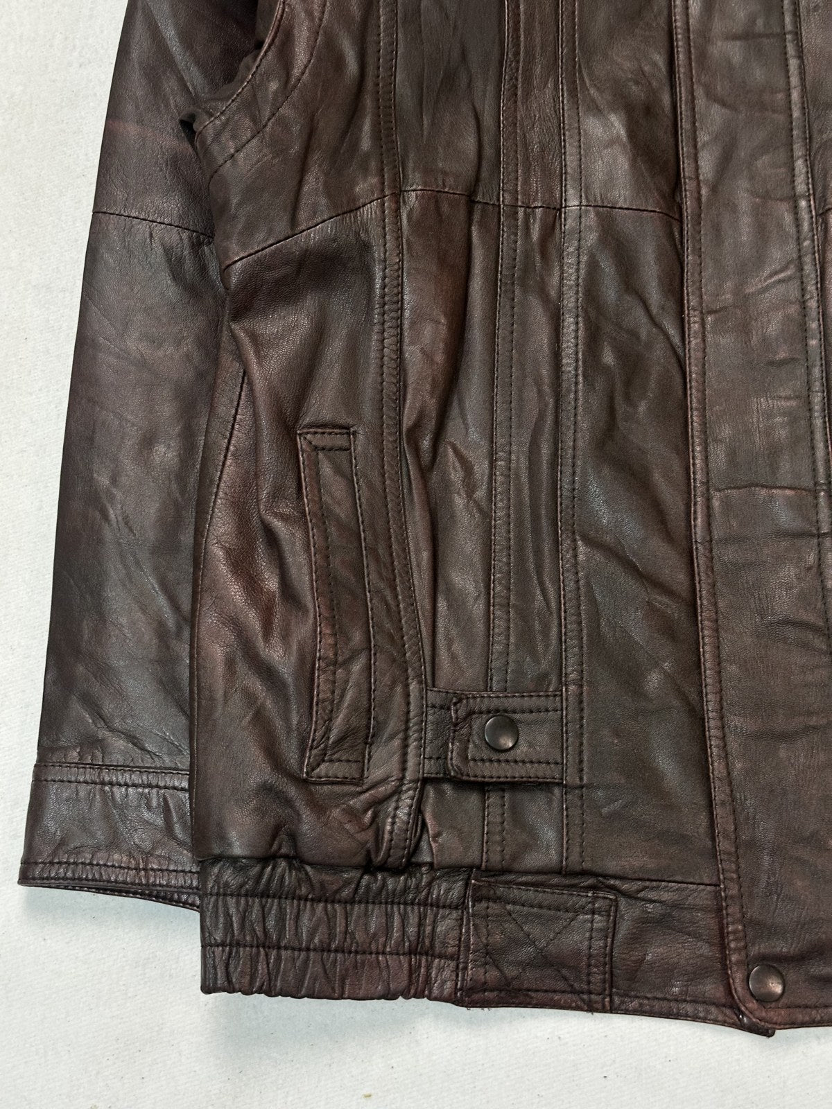 Close study of a flap pocket and its stitching on the burgundy size L bomber jacket