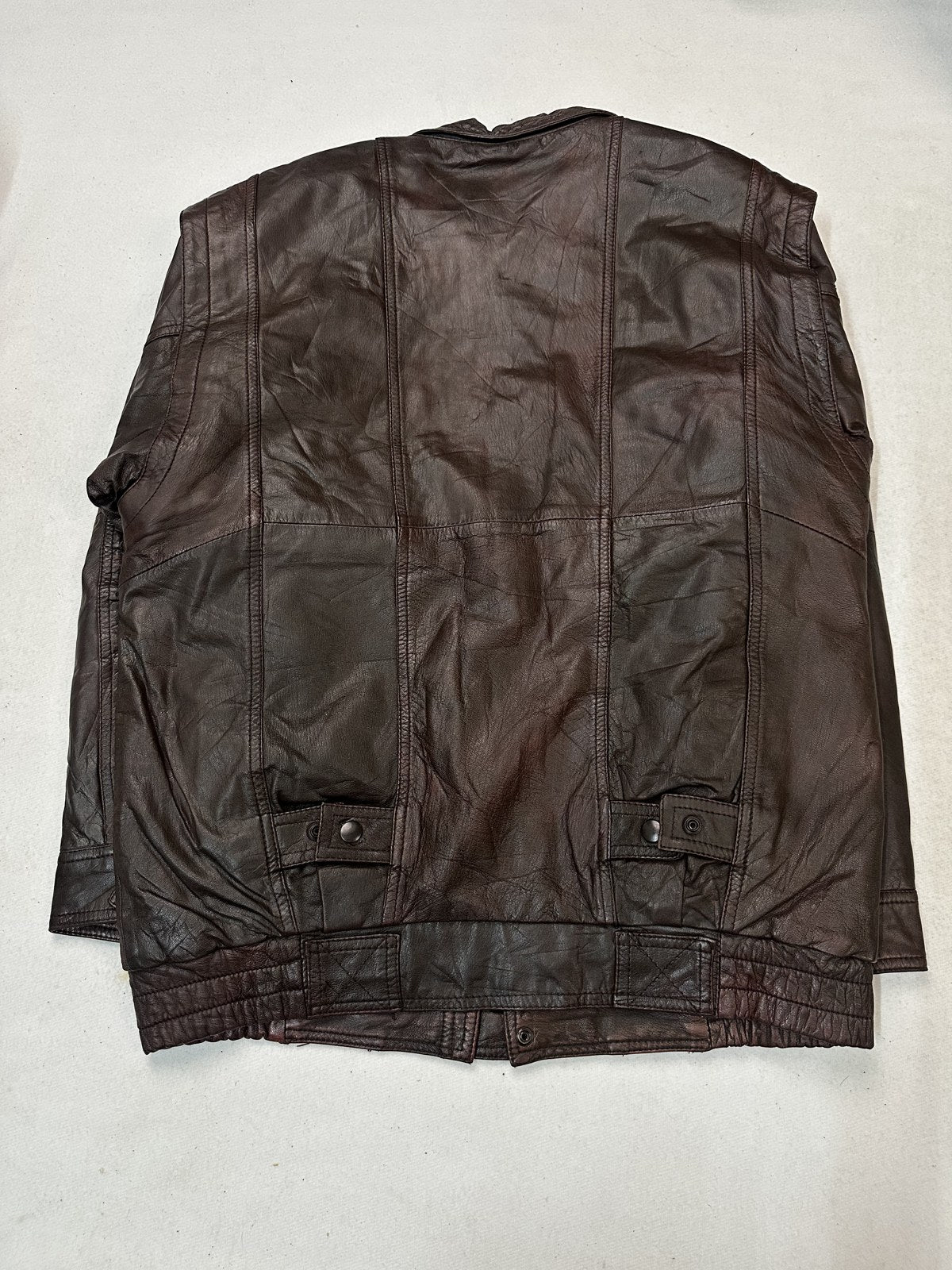 Back panel of the twin pocket burgundy bomber in size L with the ribbed waist visible at the hem