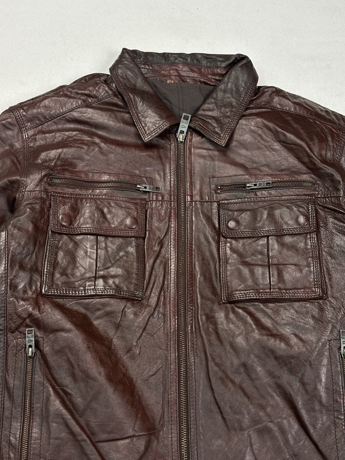 Rear view of the roomy XXL burgundy bomber jacket laid flat