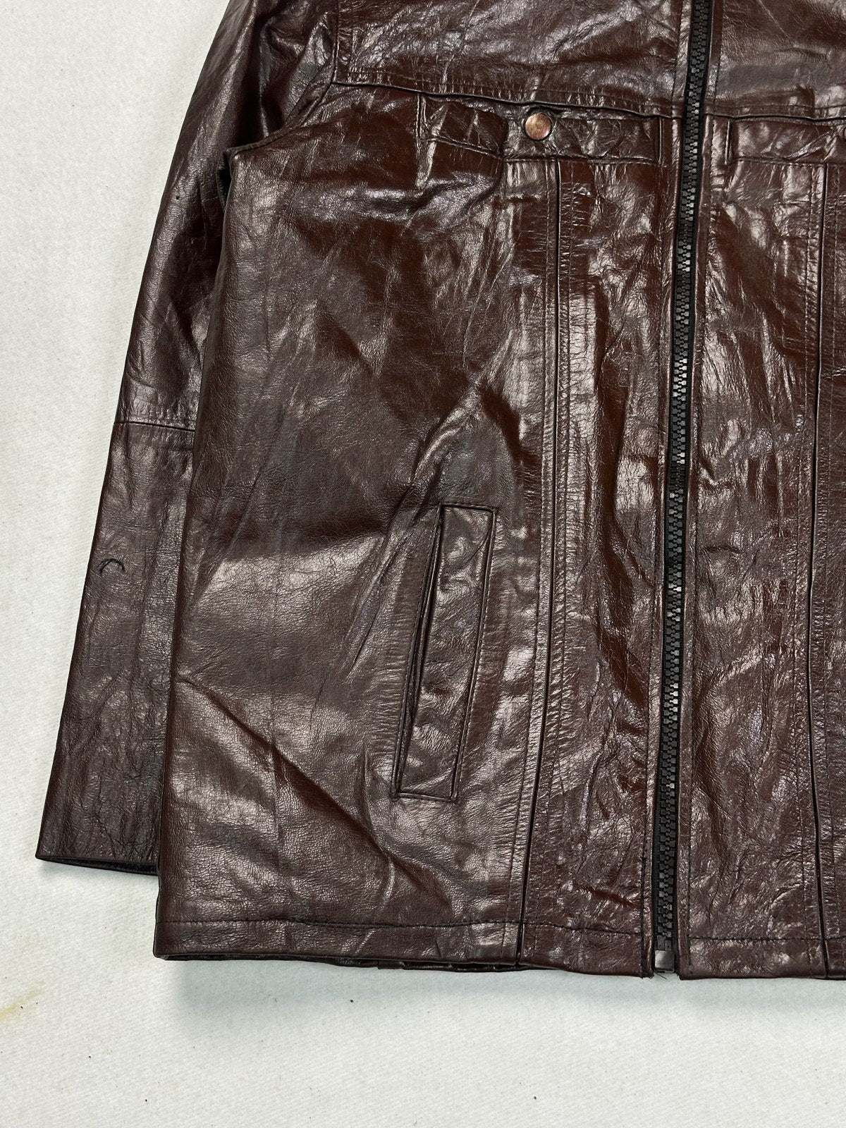 The short band collar of the burgundy panelled bomber jacket, close up