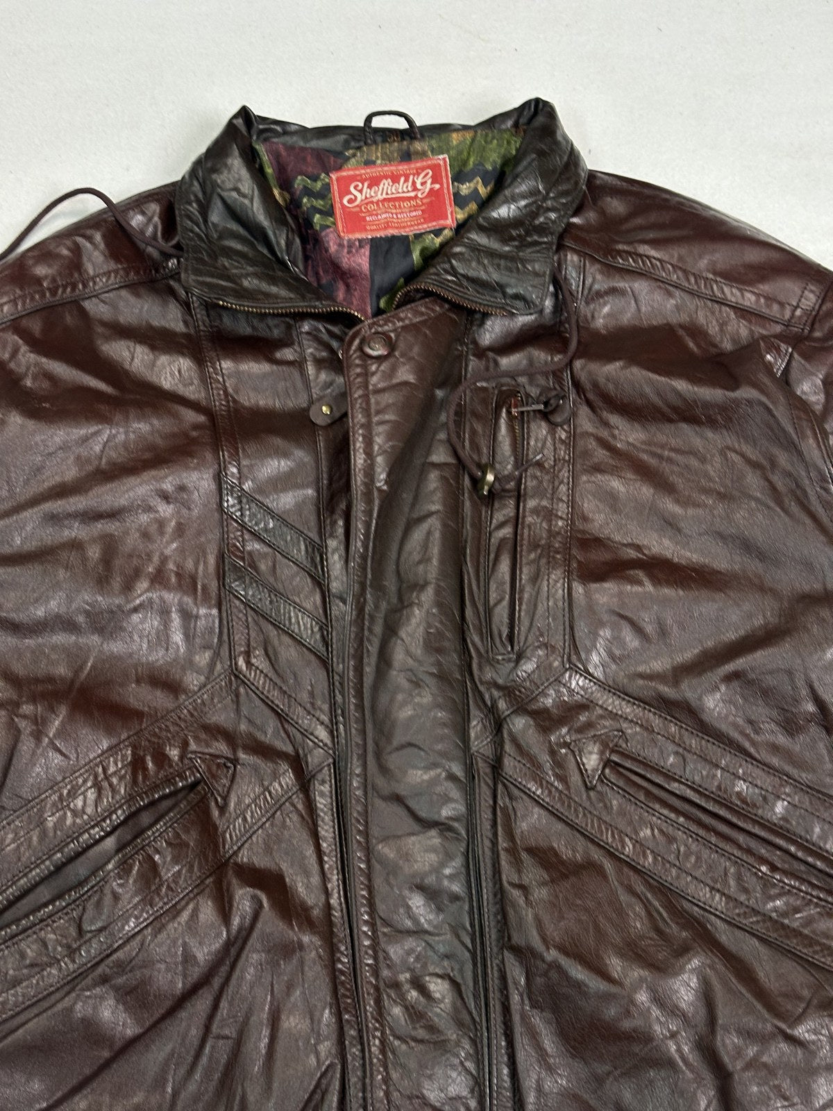 Rear view of the XL burgundy bomber showing the full back panel above the ribbed hem