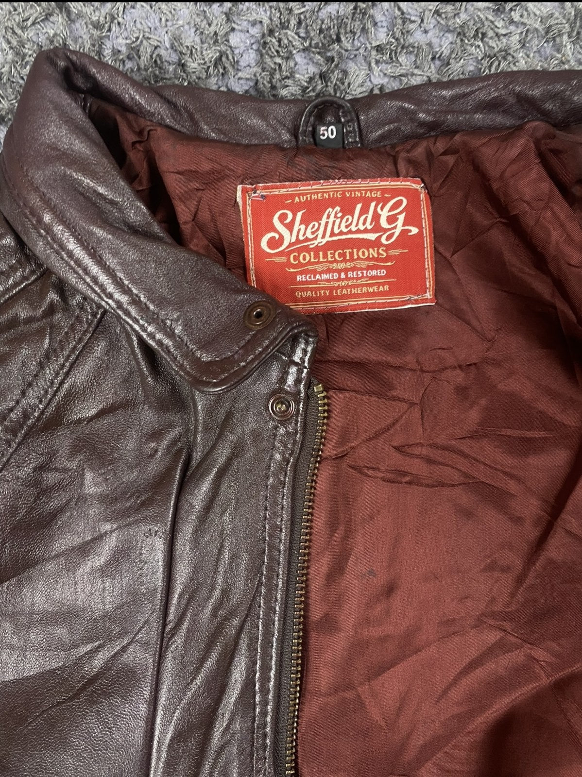 Deep oxblood lining inside the XXL burgundy leather bomber jacket