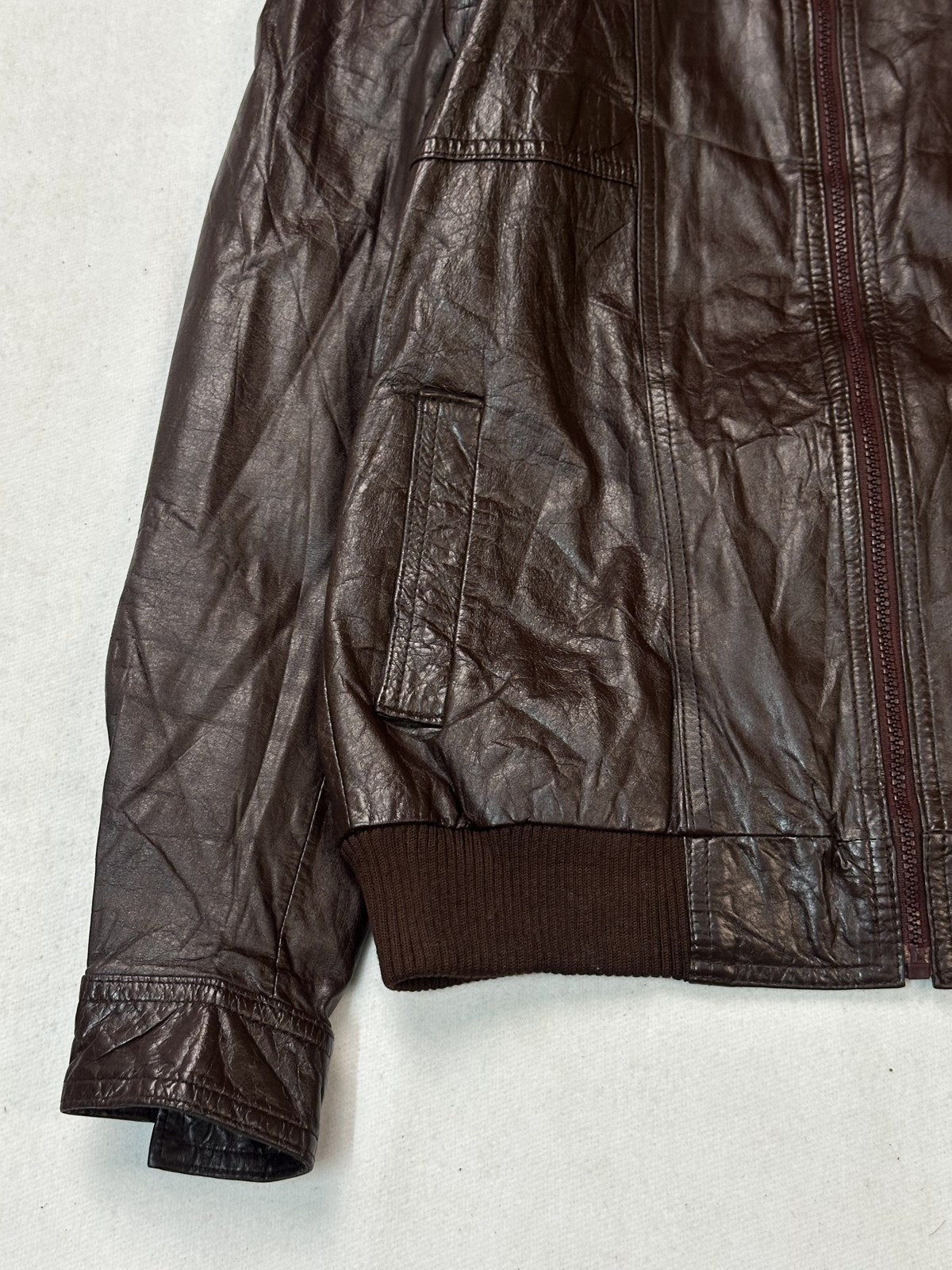 Ribbed hem and cuff detail on the size M burgundy bomber jacket