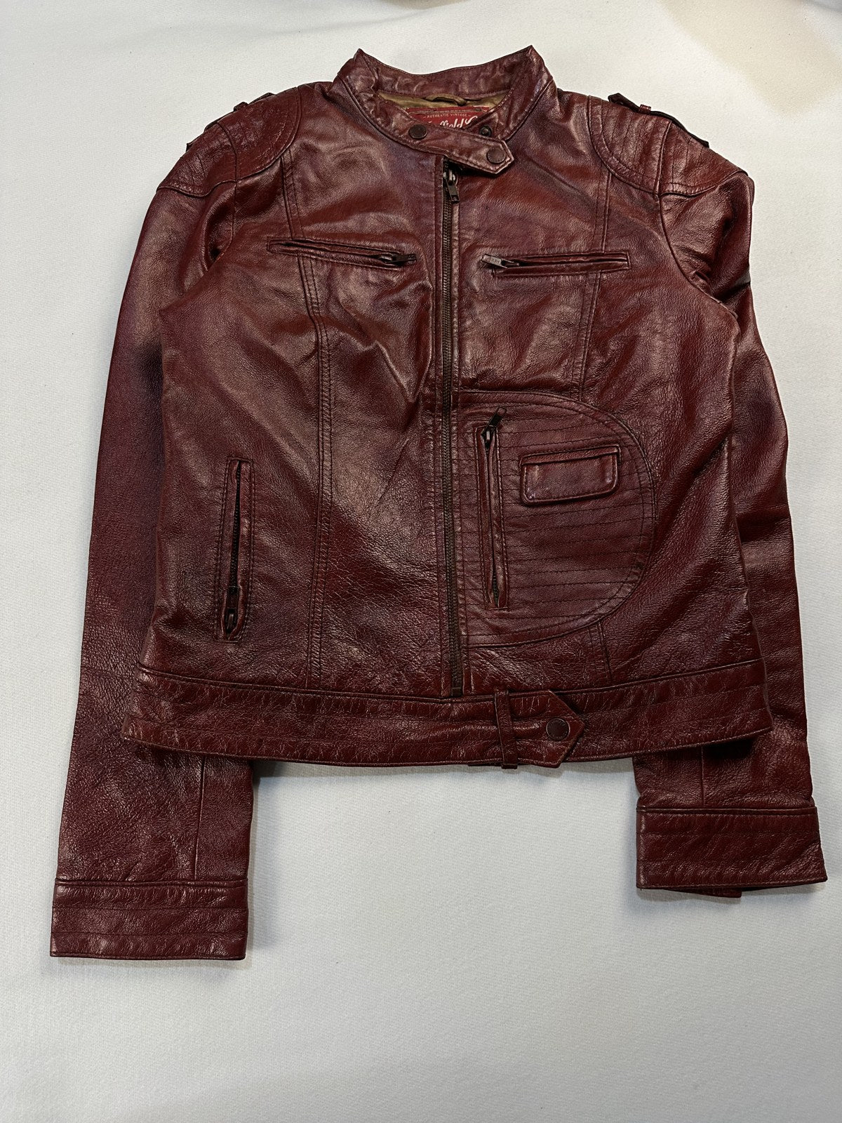 Burgundy leather cafe racer jacket in size XS laid flat from the front
