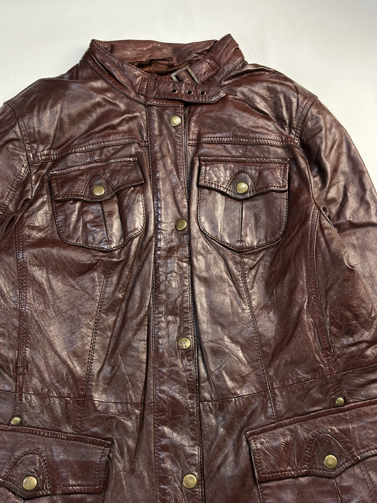 Throat strap collar on the burgundy leather field jacket
