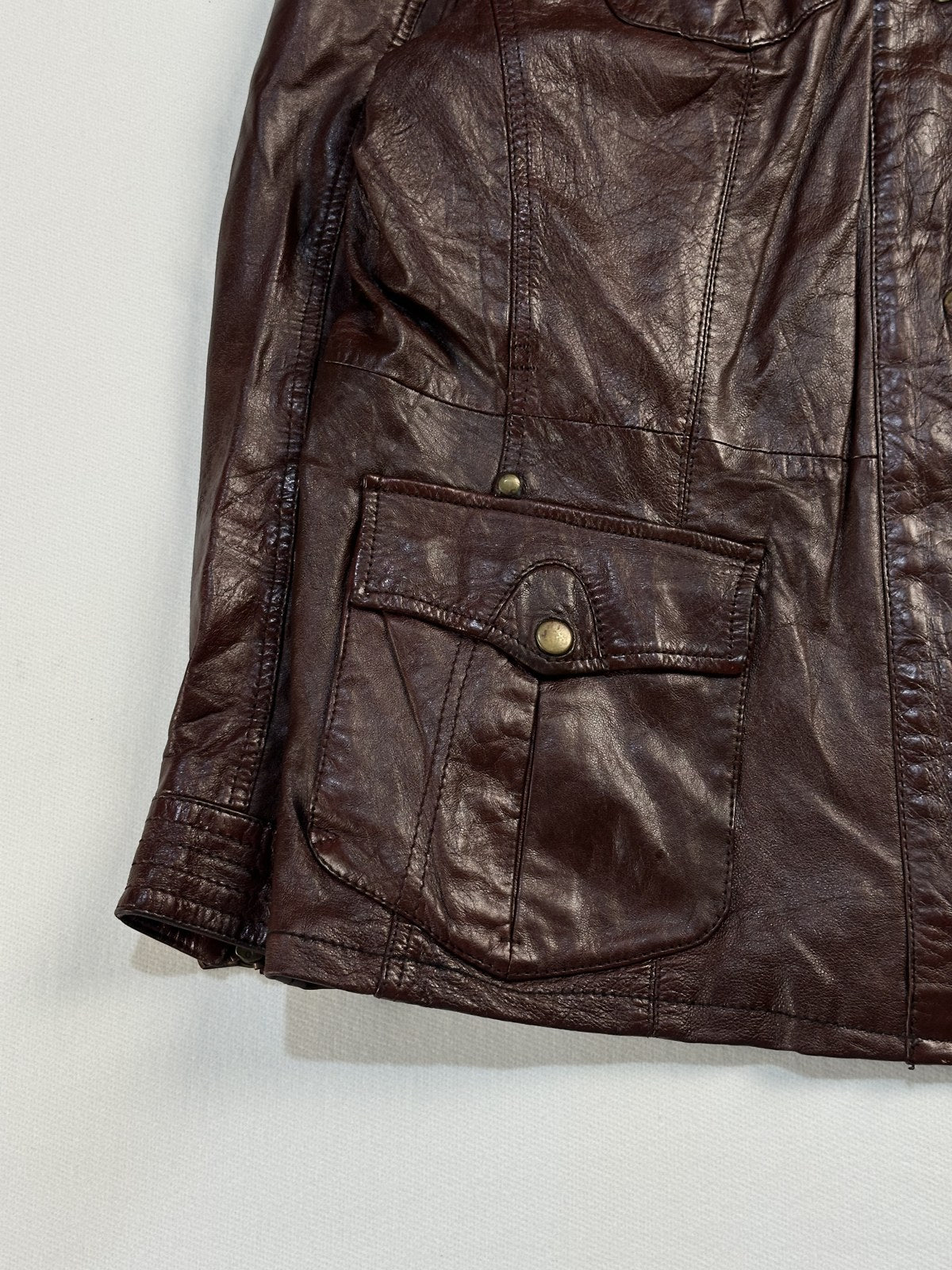 Close view of the leather grain and stitching on the burgundy jacket