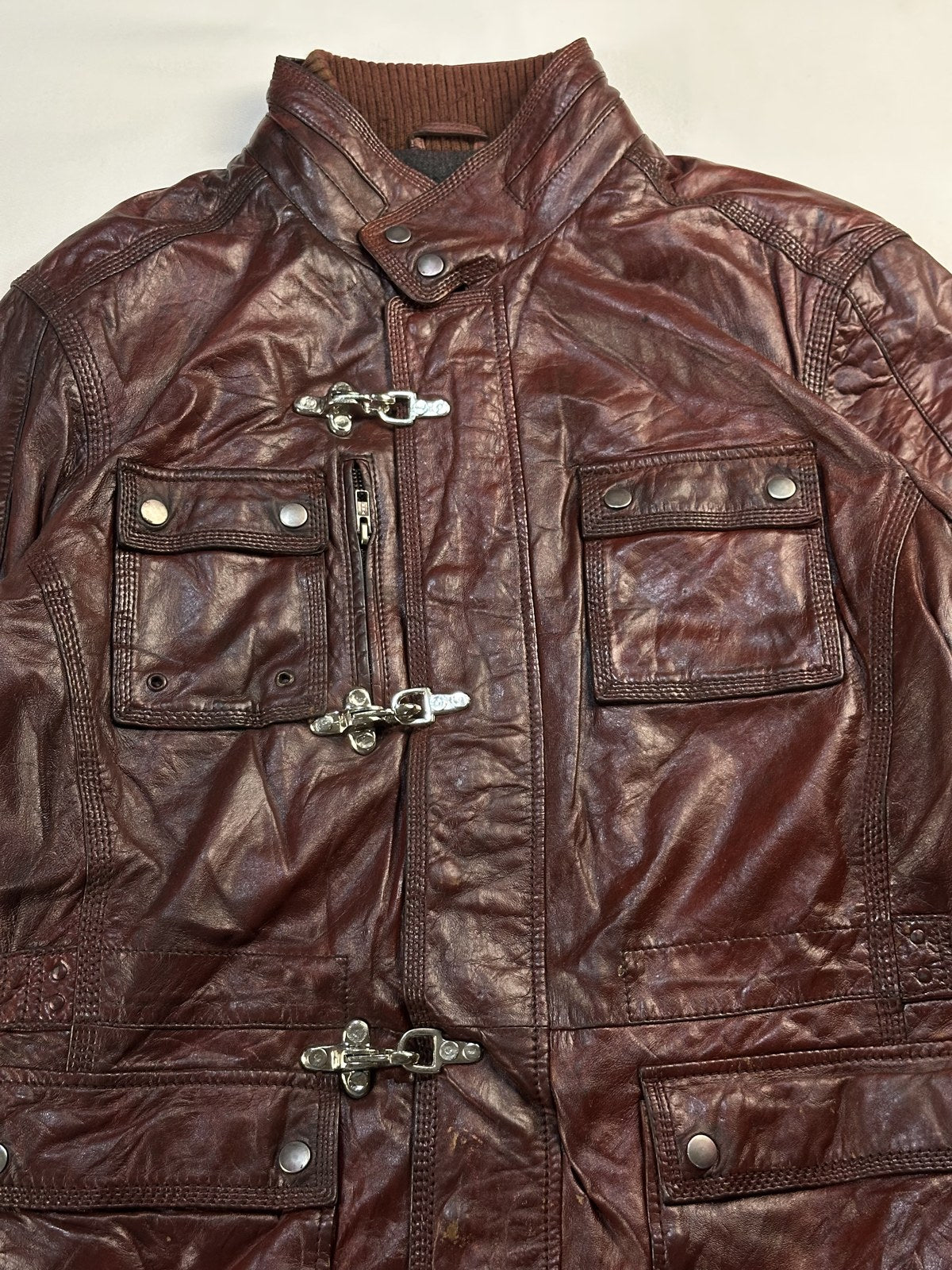Collar and chrome hook clasp on the burgundy field jacket