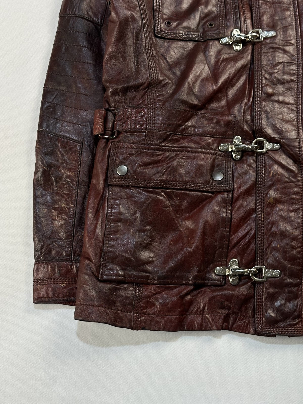 Close view of the leather grain and stitching on the burgundy jacket