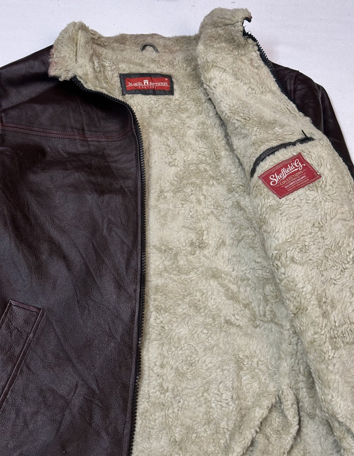 Inside of the burgundy L flight jacket showing the fleece lining running down the body