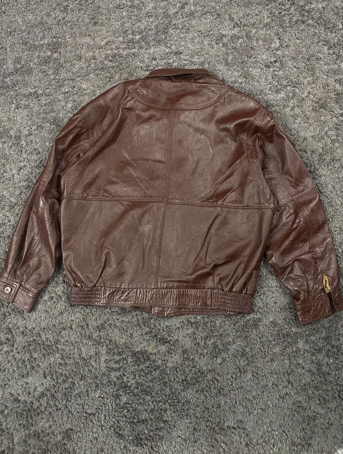 Rear view of the size XL burgundy flight jacket and its ribbed hem