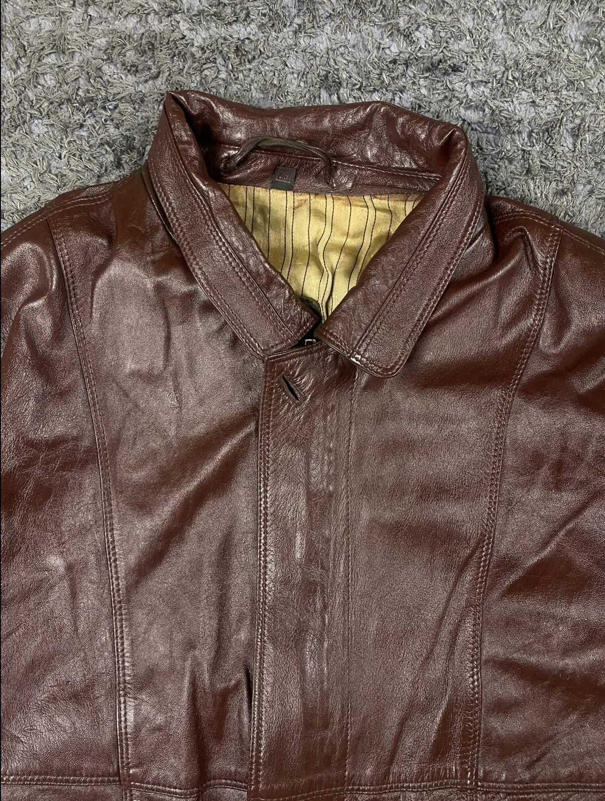 Striped woven lining inside the XL burgundy leather flight jacket