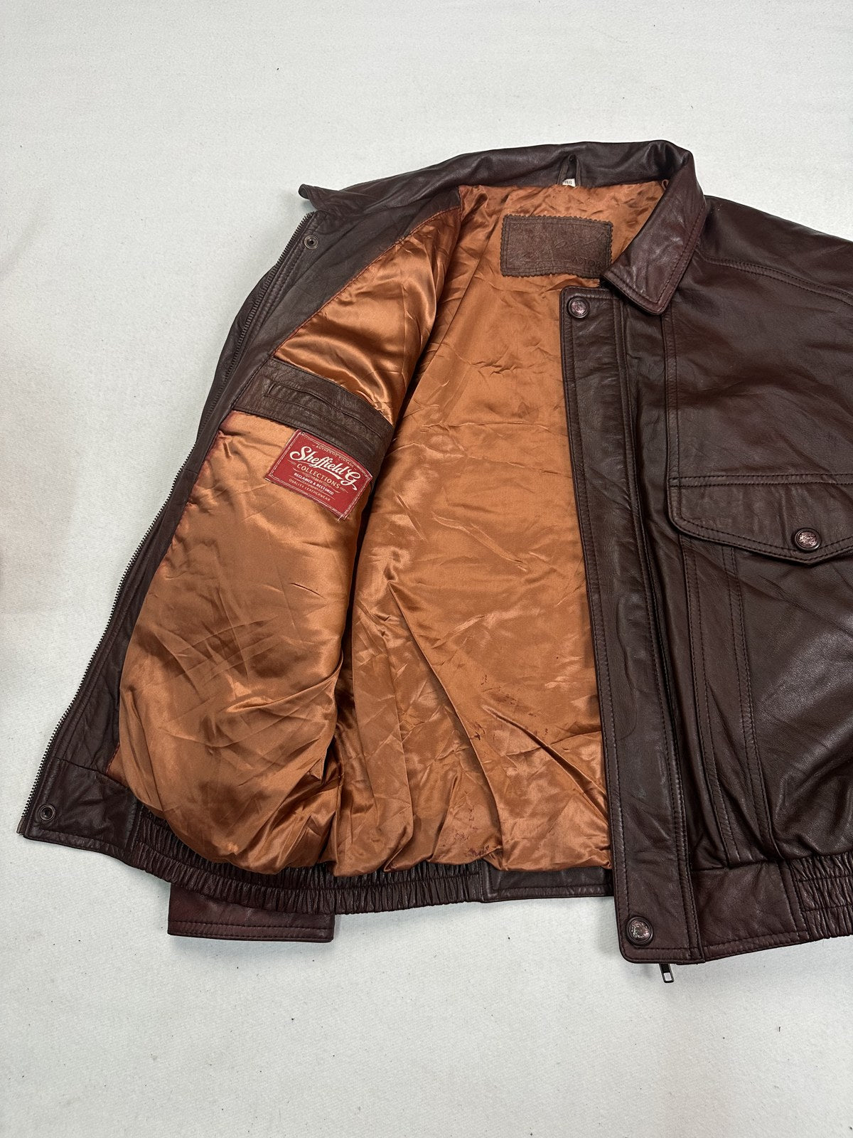 Copper satin lining inside the size XL burgundy flight jacket