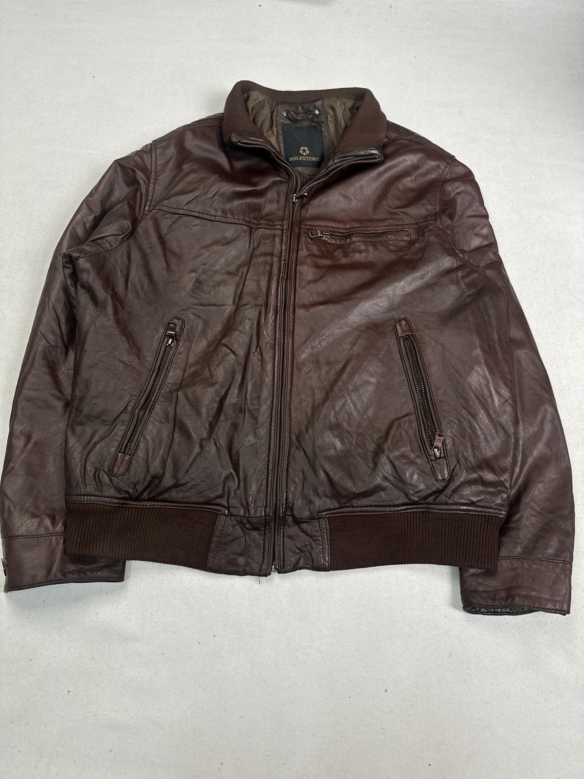 Back of the XL burgundy flight jacket with the ribbed hem across the bottom