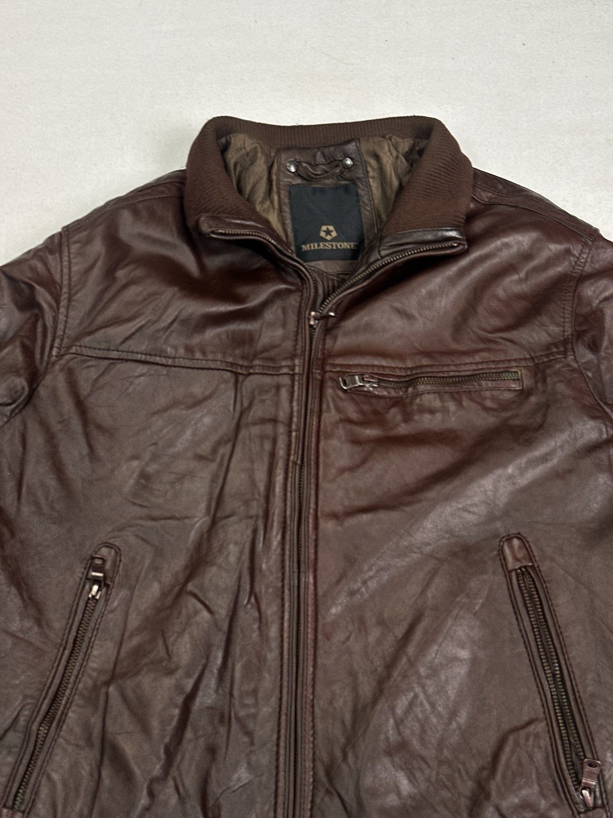 Rib knit cuff and sleeve detail on the size XL burgundy flight jacket