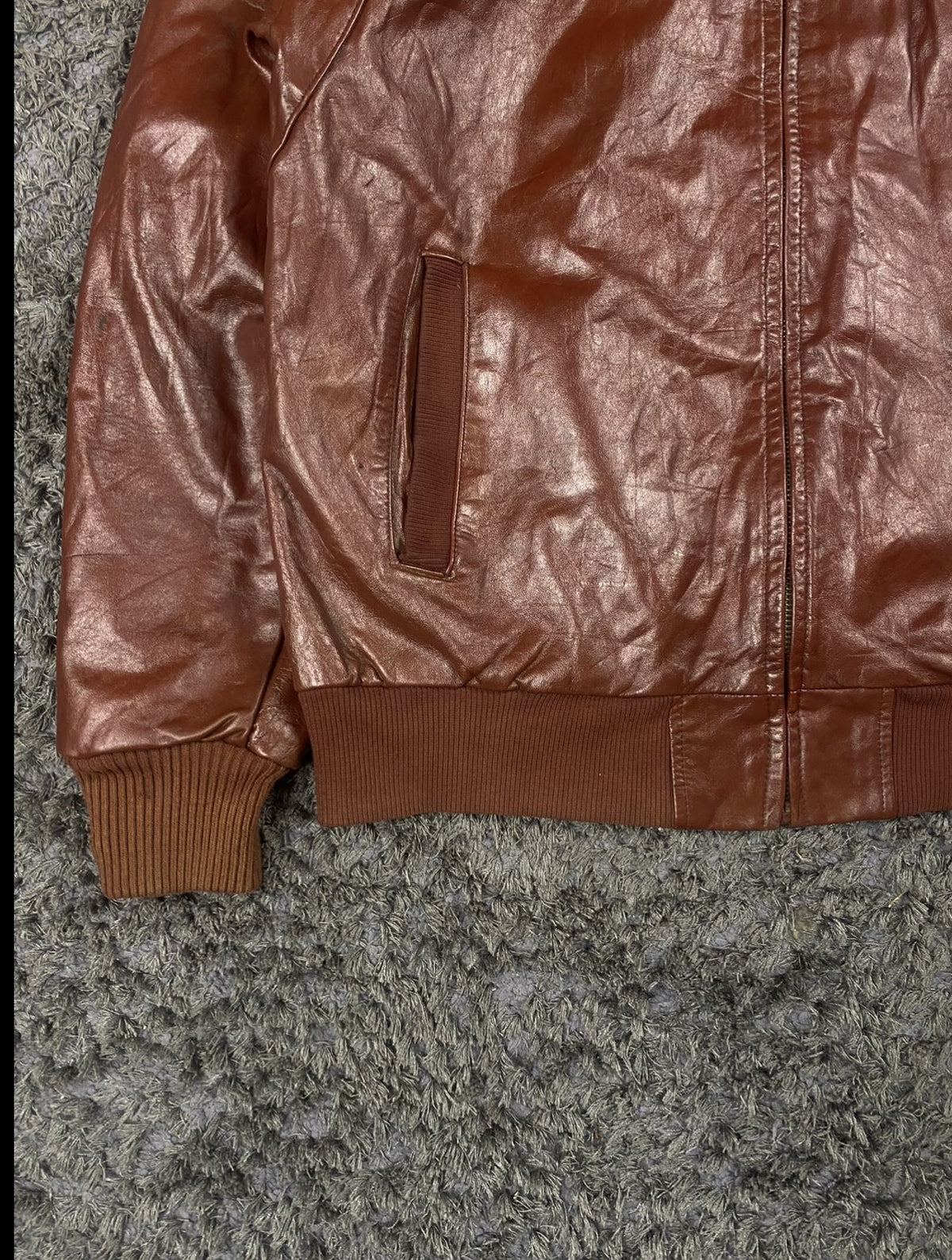 Knitted rib cuff detail on the burgundy leather flight jacket