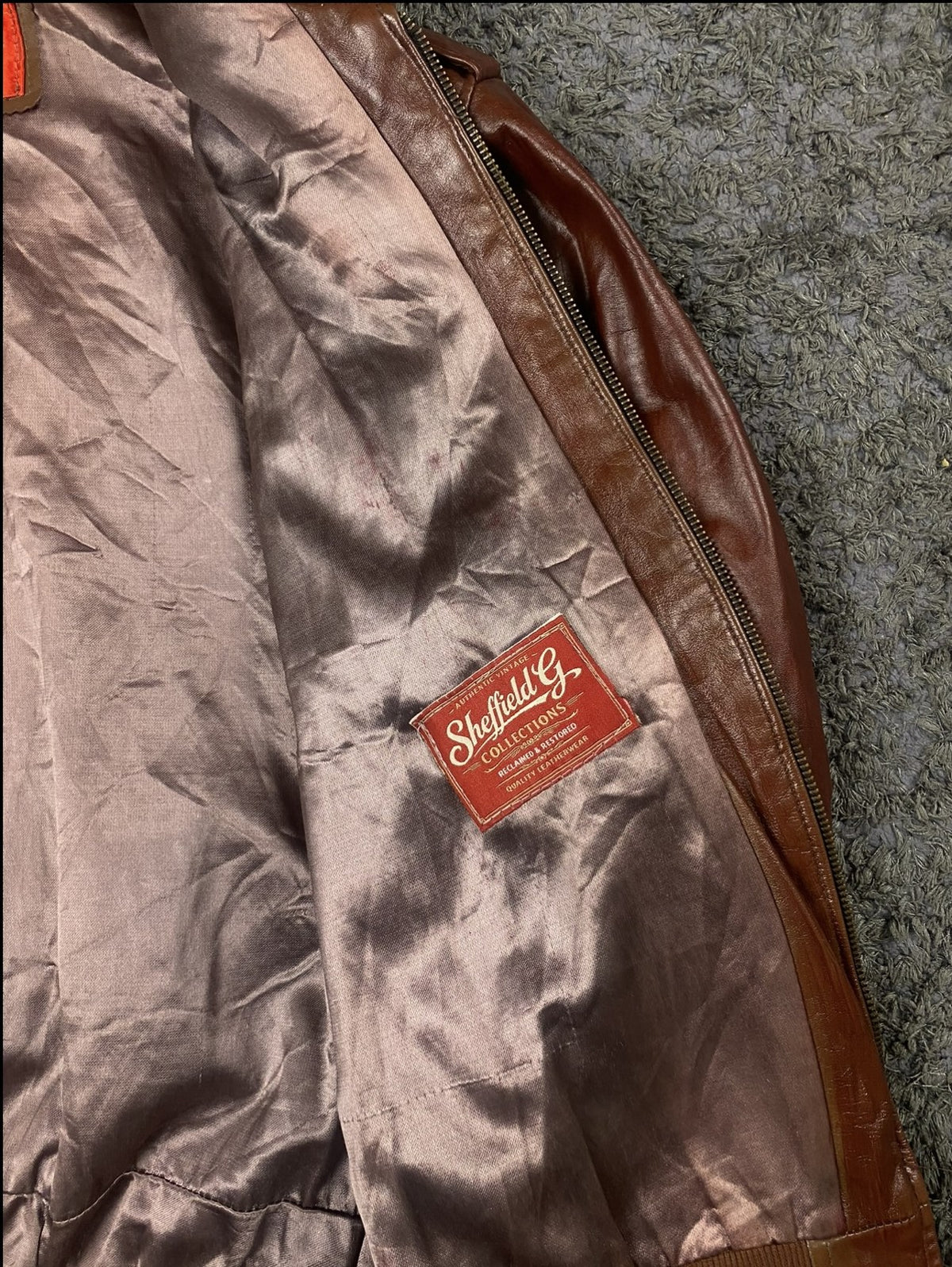 Satin lining inside the size M burgundy leather flight jacket