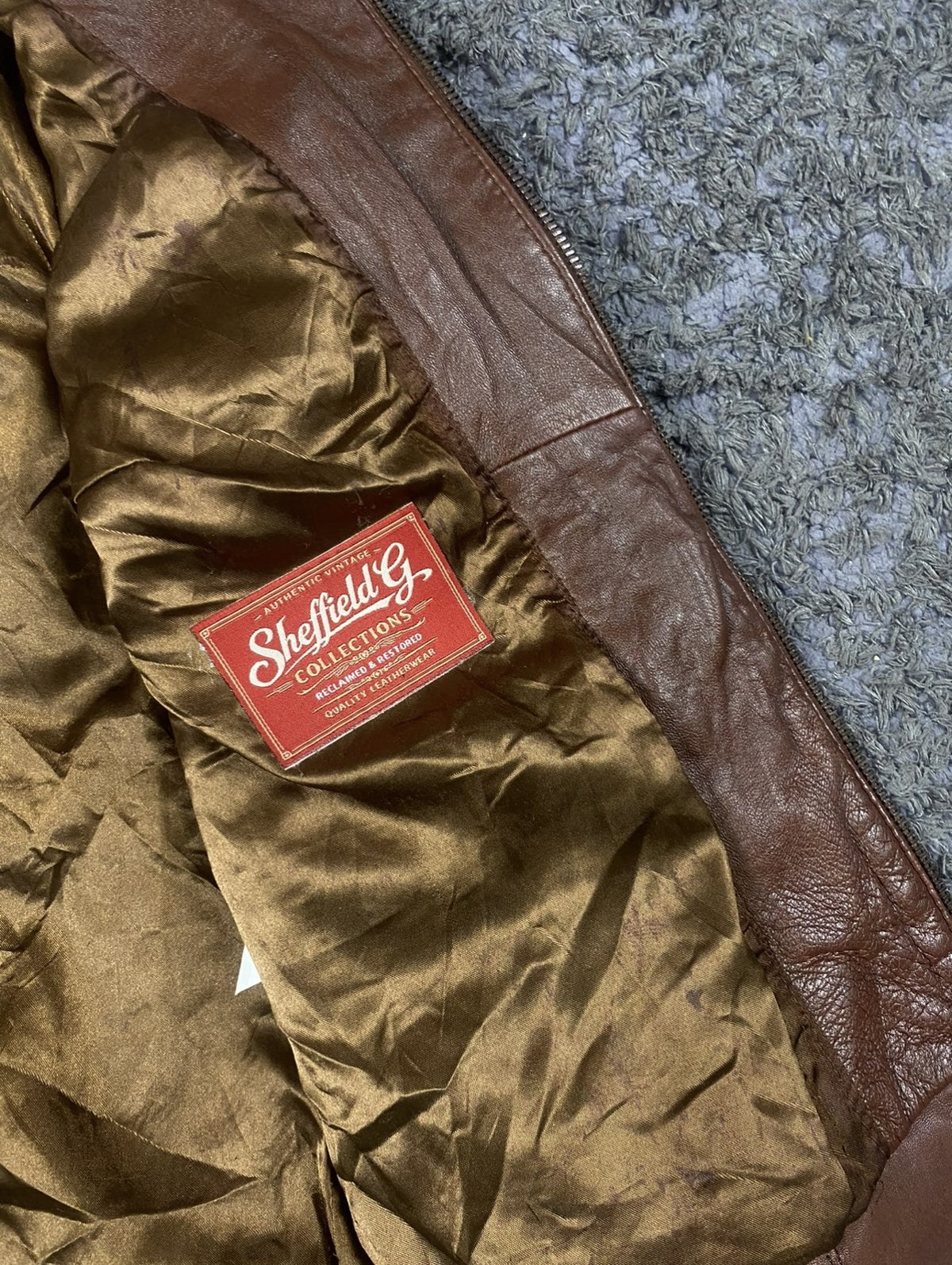 Olive satin lining inside the burgundy leather flight jacket