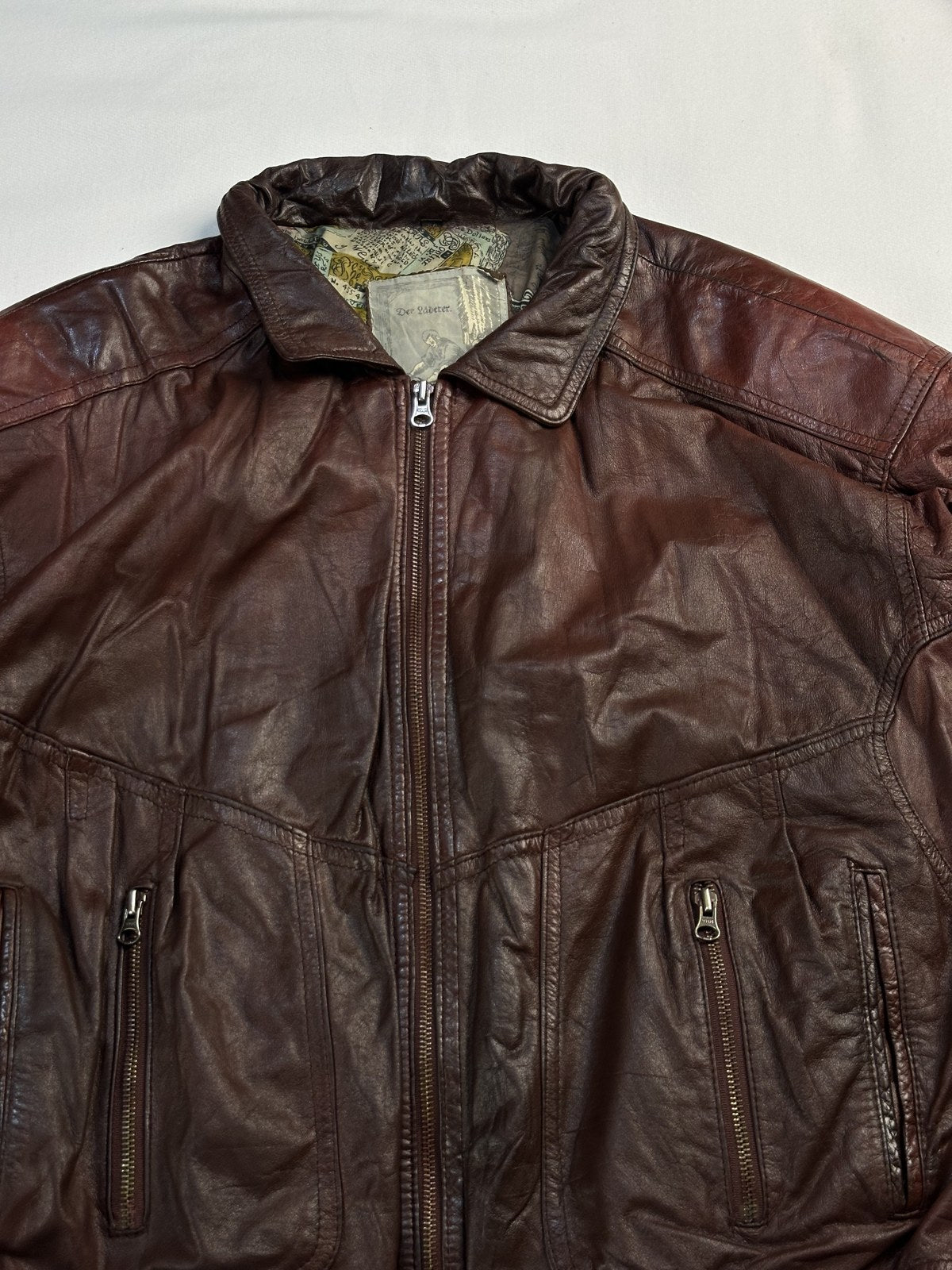 Ruched collar at the neck of the burgundy leather harrington