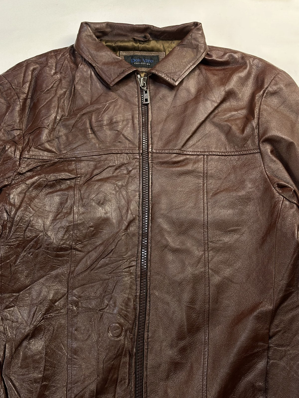 Collar and the chest yoke seam on the burgundy harrington