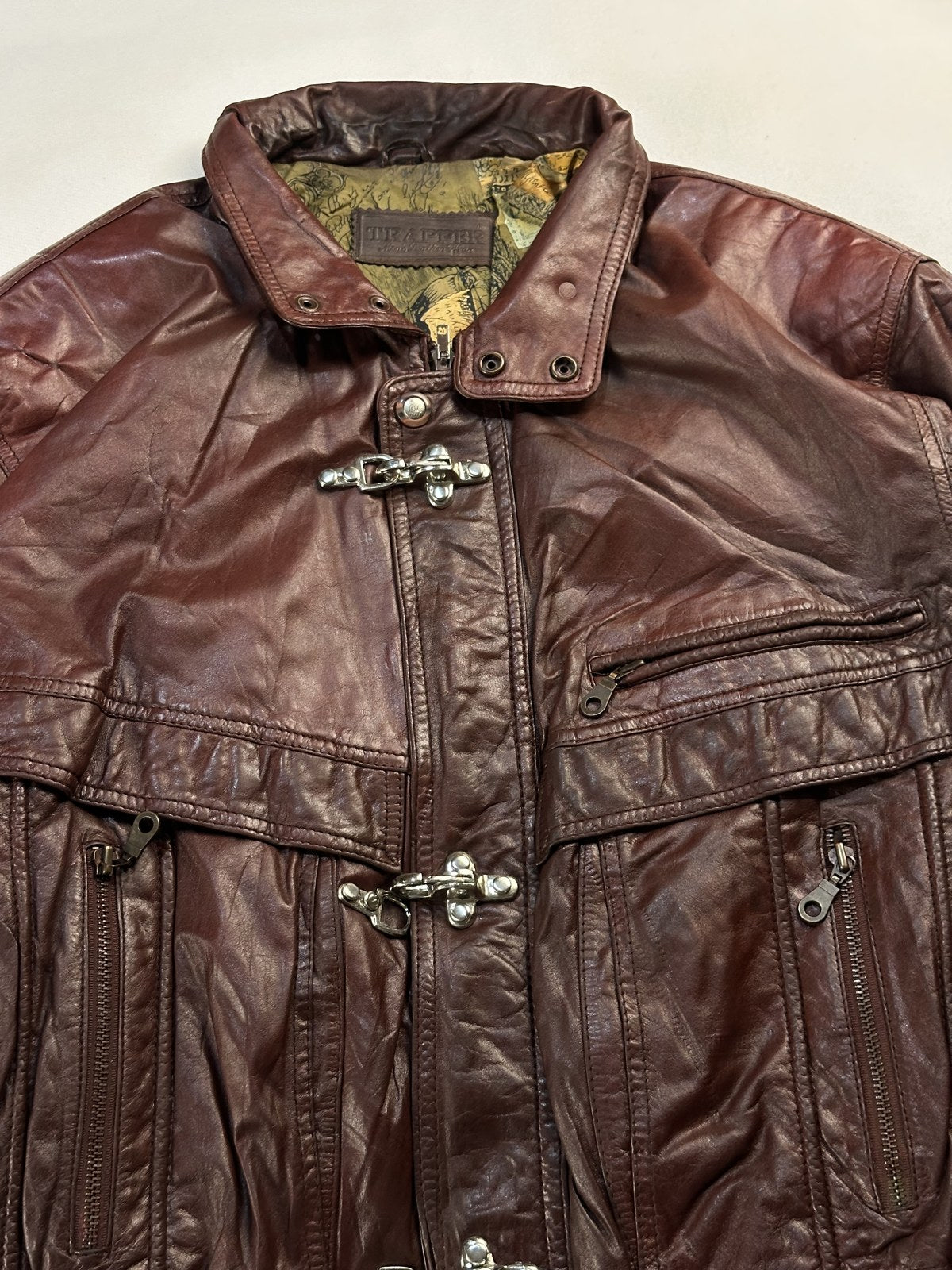 Collar and silver hook clasp on the burgundy harrington