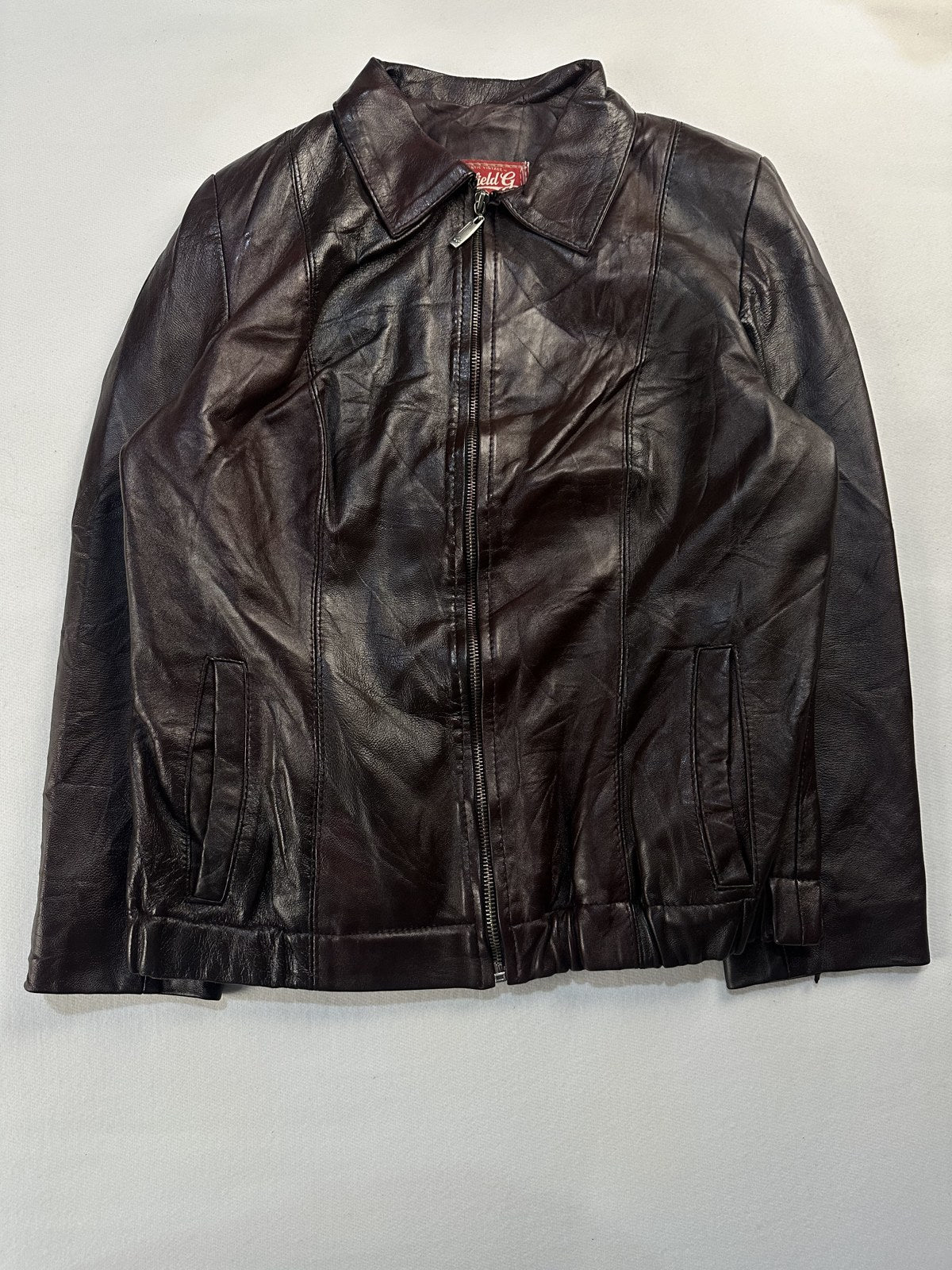 Burgundy leather harrington jacket in size M laid flat from the front